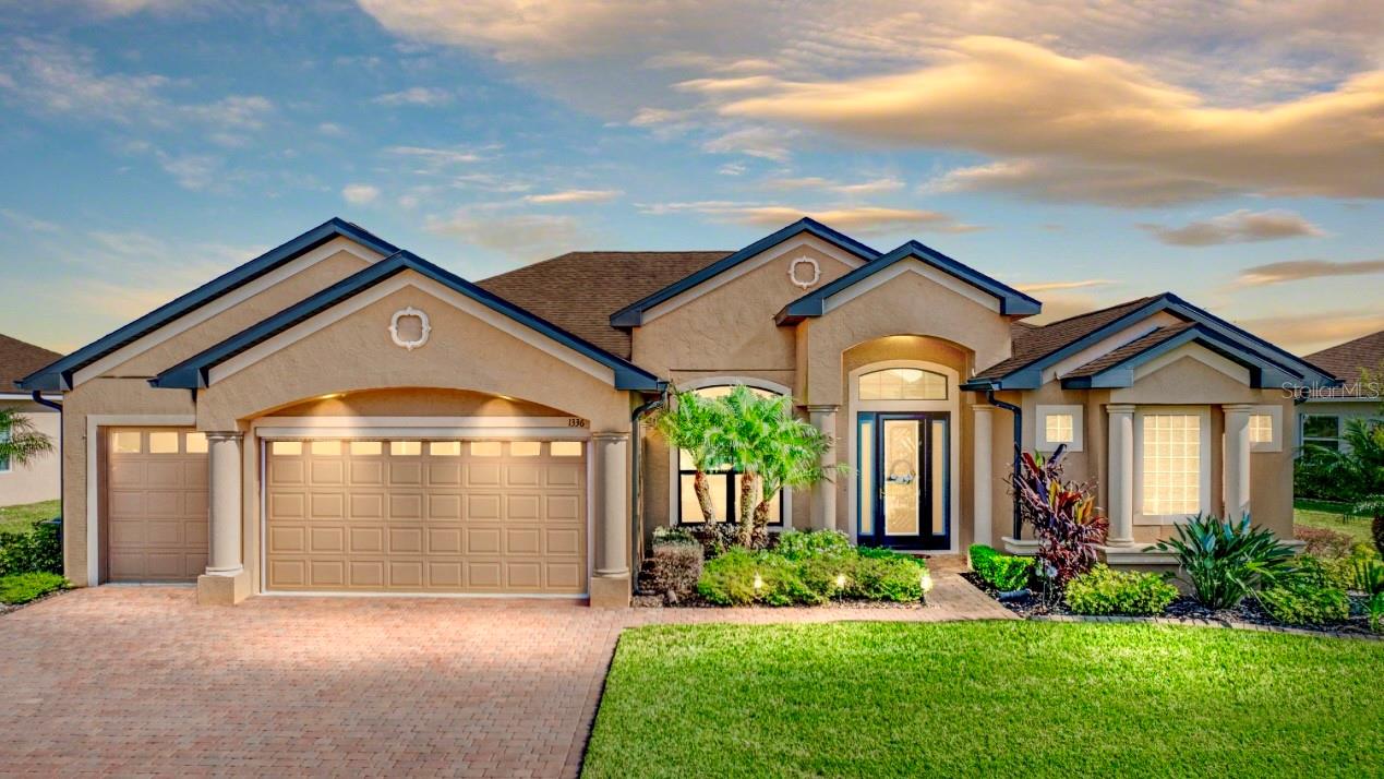 Welcome to your personal haven and next chapter in beautiful Lake Ashton—Central Florida’s premier 55+ active-adult community. This immaculate oasis radiates style, elegance, and Florida charm at every turn. From the striking bronze facia and windows to the fresh paint scheme and professional landscaping with concrete curbing, to the panoramic bronze-domed screened lanai with custom outdoor kitchen overlooking the pond, this exquisite 3-bedroom, 2-bath, 2,773 sq ft Plantation floor plan home delights with detail. Rich Nottaway Hickory 5” wide plank wood floors flow gracefully through the foyer, living and dining rooms, breakfast room, and hall, all accented by 5 ¼” crown molding in the foyer, living/dining room, kitchen/breakfast room, and primary bedroom. The living room and primary bedroom are enhanced with coffered ceilings and custom fans, while the family room has been extended 5’ for added living space. Throughout the home, extensive lighting, custom fans, hardware, and plumbing fixtures elevate its beauty. At the heart of the home, the gourmet kitchen shines with KitchenAid stainless appliances, built-in ovens, a 30” cooktop, 22.7 cu ft refrigerator, Reagan maple cabinetry with three banks of drawers, countless custom features, and a striking 4” granite backsplash, complemented by granite counters in both the kitchen and the baths. The luxurious primary bath offers frameless shower glass, his-and-her vanities, and a jetted tub. Multiple pocket doors are throughout the home. Plantation shutters grace every window, including French doors that open to a paver-floored veranda measuring an expansive 23’ x 28’, complete with outdoor kitchen, creating a seamless connection to nature. The property’s oversized lot abuts a tranquil seasonal pond and nature preserve, offering stunning views and ultimate privacy. Built with over $154,000 in custom builder upgrades and enhanced with the owners’ thoughtful touches, this six-year-old home is a showcase of tasteful luxury, equally perfect for entertaining and a private, quiet retreat. Beyond the home, Lake Ashton offers a lifestyle like no other, with two 18-hole championship golf courses, a 26,000 sq ft clubhouse, a state-of-the-art Health & Fitness Center, indoor and outdoor pools, pickleball courts, a bowling alley, theater, on-site restaurant, and an ever-active calendar of social events and clubs. Don’t miss the chance to make this warm, welcoming, and beautifully appointed home your very own—schedule your private showing today and discover the Florida dream waiting for you.