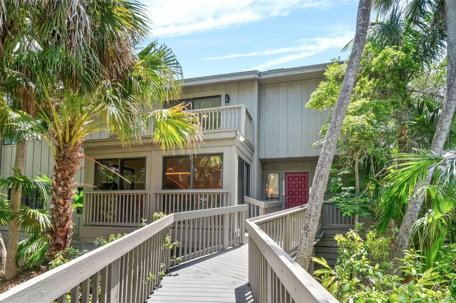 Tucked away in the highly sought-after community of The Landings, this inviting townhouse on the boardwalk, a very special location, offers the perfect blend of privacy, natural beauty and comfort. Surrounded by matures and lush foliage, this home provides a serene, wooded setting  with partial bay views. Inside, you'll find a contemporary style throughout the 3 bedrooms, 2.5 baths and generous sized bonus room ideal for a home office, media space or guest quarters. Large windows and sliding glass doors fill the interior with an abundance of natural light, offering seamless views of the surrounding greenery and opening onto an expansive deck - perfect for outdoor entertaining or quiet relaxation. Enjoy the community amenities, including a sparkling pool, scenic nature trail and direct bay access, all while being minutes from the area's best dining, shopping, beaches and downtown Sarasota. Membership to the Landings Racquet Club is voluntary, offers additional amenities and a center for social activities.
