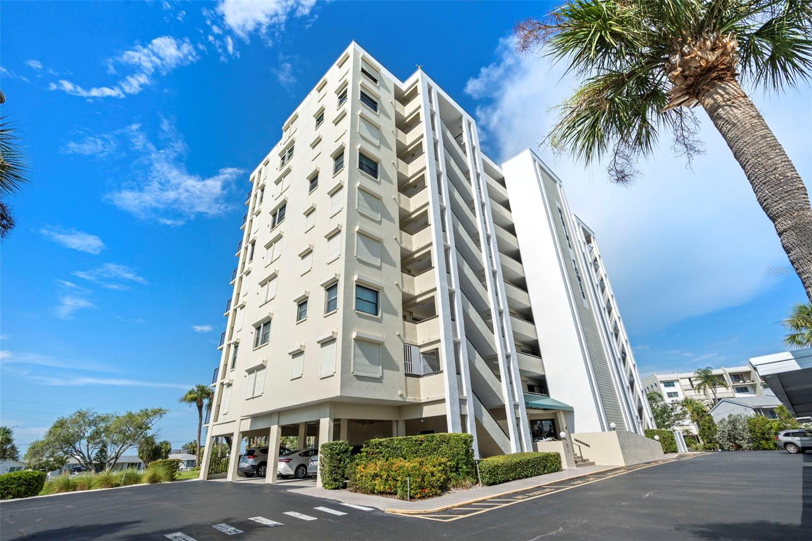 Breathtaking, panoramic water view from this 9th floor condo in Marina Towers! Waterlines greet you as you step inside to find a welcoming split floor plan of 2 bedrooms and 2 bathrooms. The warm and inviting kitchen comes equipped with spacious Corian countertops, ample cabinetry with pull out drawers, appliances, washer and dryer. This open space flows to the dining and living areas, all with a gorgeous view of the intercoastal. Step outside onto the secluded balcony to watch the dolphins play and spectacular sunsets! Bathrooms are remodeled showcasing tiled showers with glass doors and vanities with granite. Brand new A/C and newer hurricane windows and sliders throughout. This home includes one of the exclusive under building covered assigned parking spaces! Enjoy the heated pool year-round along with the clubhouse equipped with pool/ping pong table, treadmill, books, games and tv. Discover beautiful beaches at Honeymoon Island State Park which can be accessed by bike, or a short drive. You will find the Pinellas Bike Trail, golfing, restaurants, grocery stores and banks all within the area. Drive or bike north to Tarpon Springs and the sponge docks or south to quaint downtown Dunedin. There was no water intrusion in this building during last year’s hurricanes. This truly is a hidden oasis that you must see and make your new home today!