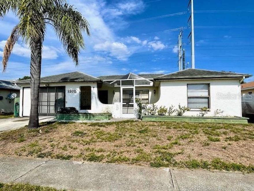 Fixer-Upper with Great Potential in Holiday, FL: Opportunity knocks with this 2-bedroom, 2-bath home featuring a 1-car garage, ideally located near the famous Tarpon Springs Sponge Docks for shopping and dining, and just a short drive to beautiful Anclote River Park, Key Vista Park or Howard Park and their Gulf Coast beaches—making it a smart choice for homeowners and investors alike. Inside this 1,615 sq ft block-constructed residence, built in 1985, you’ll find a spacious family room complete with a built-in wall unit featuring a Murphy bed, along with a separate living/dining room combination. This flexible layout offers multiple renovation possibilities, including the potential of enclosing the family room to make a third bedroom, home office, or hobby space. The two bedrooms share a full bathroom, while a separate guest bath is conveniently located just off the kitchen—perfect for visitors and everyday use. The centrally located original kitchen provides easy access to both the guest bath and main living areas and is ready for your personal updates and finishing touches. Step outside to a manageable yard with plenty of potential to create your own outdoor retreat—whether you envision a garden, patio, or entertaining space. The attached one-car garage adds convenience and additional storage. Whether you’re looking to customize your first home, downsize, or invest, 1202 Mandarin Dr is full of opportunity and ready for your vision.