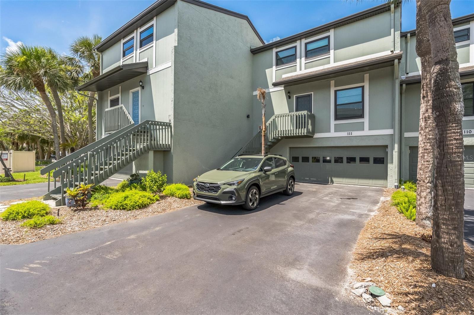 This three-story townhome features 2 bedrooms/2.5 bathrooms within a large 1,583 sq. ft. of living space. The kitchen has been remodeled with painted wooden cabinets, granite countertops, stainless-steel appliances, and a breakfast bar. Updated flooring throughout. The primary bathroom features a double sink and wooden cabinet. Includes a dedicated laundry area.
The home has a private balcony with an attached 2-car garage located on the ground floor, with the main living space on the second and third floors. Living areas are on the second and third floors. Located in the Island Village community, which offers residents access to two pools, as well as tennis and pickleball courts.