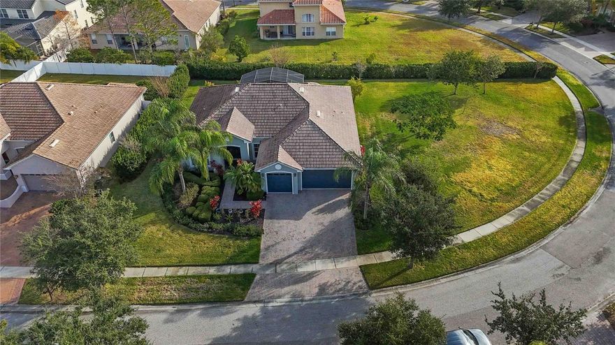 Pristine home on a nearly half-acre private lot in the award winning, 24-our guard-gated Bellalago community. This beautifully maintained 4-bedroom, 2-bathroom home offers 2,257 sq ft of living space, a 3-car garage, soaring ceilings, and a bright, open floor plan with tranquil views of mature landscaping.  The open kitchen features granite countertops, 42” cabinetry, stainless steel appliances, center island, breakfast bar, desk area, and closet pantry, flowing seamlessly into the family room and sunlit dinette. Sliding doors lead to an expansive screened back patio, ideal for outdoor living and entertaining while enjoying the oversized backyard with room for a future pool or custom retreat.
The primary suite includes a sitting area, dual custom walk in closets, garden tub, walk in shower, and dual vanities.  Fresh interior and exterior paint, a newer A/C and a tile roof with ample remaining insurable life add peace of mind. Bellalago offers a refined lifestyle with resort-inspired amenities, lake access with private boat ramps, and beautifully maintained common areas  designed for both recreation and relaxation. Conveniently positioned near shopping, dining, medical facilities, and Valencia College, this home combines space, privacy, and community living—just a short drive from Central Florida’s major attractions.