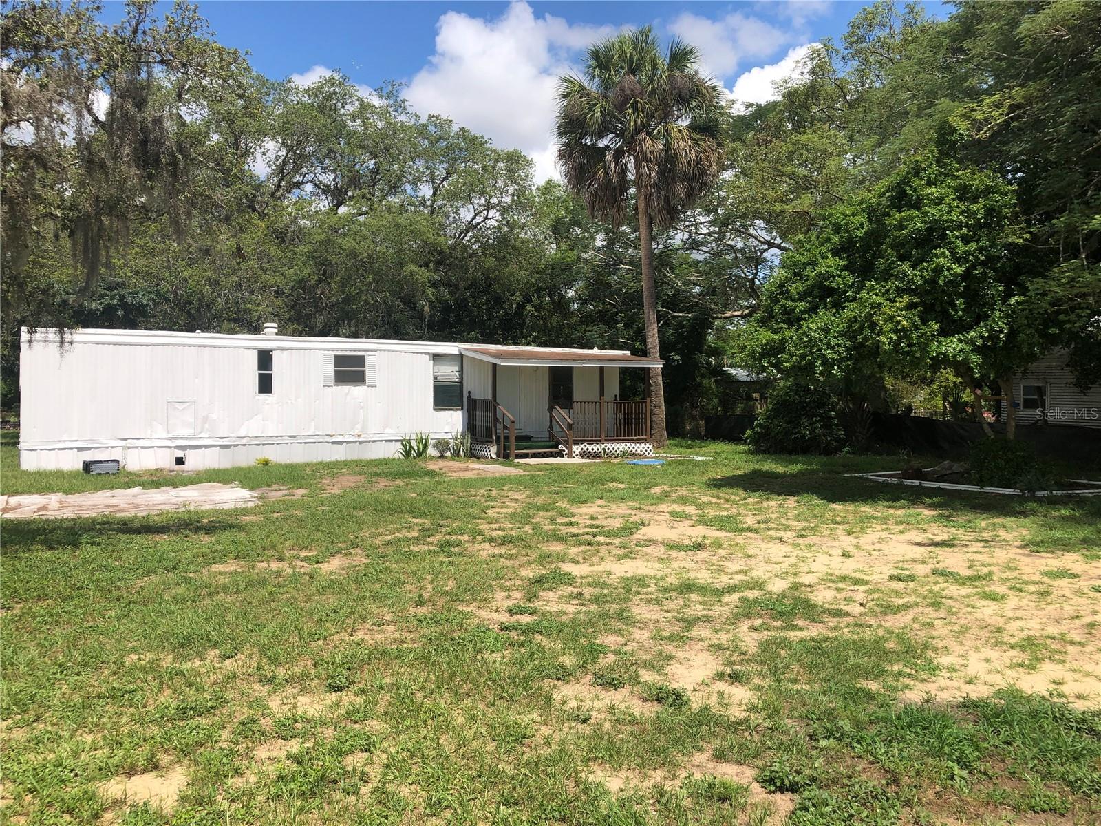 **TURNKEY PROPERTY-NO HOA/CDD** Begin collecting rent on day one with four mobile homes 100% LONG TERM occupied on over 1.5 acres! All tenants are on month to month leases allowing the new owner to adjust for market conditions. There is new construction breaking ground all around this area which will appreciate the value of the property. Each mobile home has its own septic and power; all units share one well. Two units (1-2/1 AND 1-3/2) have new metal roofs and interiors updated and two have fresh interior paint. All units have window AC. Income statements/rent rolls to be provided by Seller.
Seller finance is available. All room sizes/other information considered accurate. Buyer/Buyer's representative encouraged to verify all information independently. It is advisable to conduct due diligence with the county about potential land use (current and future), impact fee credits, and/or exemptions.