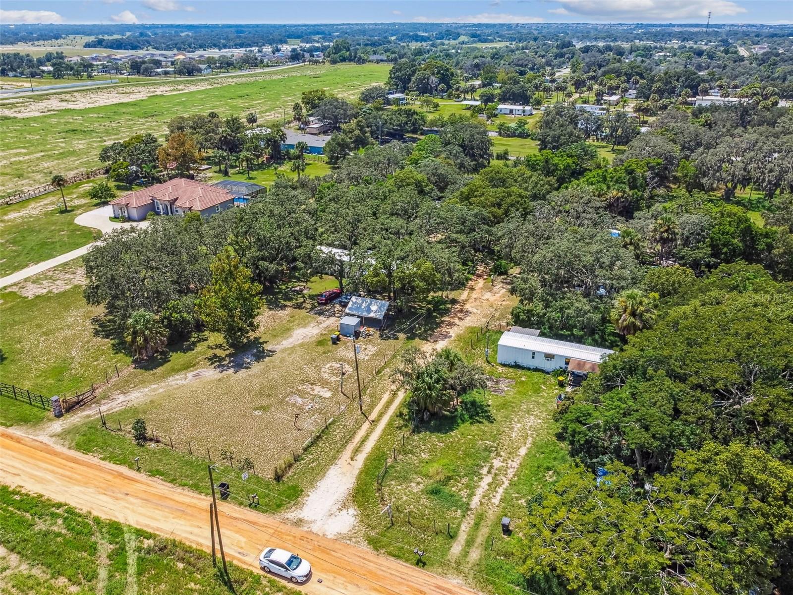 **TURNKEY PROPERTY-NO HOA/CDD** Begin collecting rent on day one with four mobile homes 100% LONG TERM occupied on over 1.5 acres! All tenants are on month to month leases allowing the new owner to adjust for market conditions. There is new construction breaking ground all around this area which will appreciate the value of the property. Each mobile home has its own septic and power; all units share one well. Two units (1-2/1 AND 1-3/2) have new metal roofs and interiors updated and two have fresh interior paint. All units have window AC. Income statements/rent rolls to be provided by Seller.
Seller finance is available. All room sizes/other information considered accurate. Buyer/Buyer's representative encouraged to verify all information independently. It is advisable to conduct due diligence with the county about potential land use (current and future), impact fee credits, and/or exemptions.