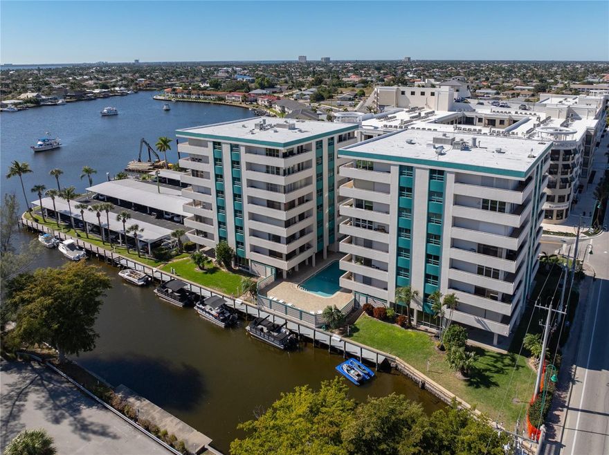 Experience waterfront living in your condo located in the Sunset Towers community of Cape Coral. Offering Direct Gulf Access with no bridges and just minutes to open water of the Caloosahathee River. Just seconds to the coming soon new seafood & cocktail restaurant and new breakfast spot right next door. This light-filled end unit features expansive sliding glass doors wrapping around the living space, creating a seamless indoor–outdoor flow and capturing views of the canal and the exciting Basin Project area. Enjoy breathtaking sunsets, gentle breezes right from your private balcony! Inside you’ll find a spacious layout for entertaining, a generous size owners suite designed for comfort and convenience with view of the canal. Unit has split bedrooms and a guest bathroom providing privacy for your guests. Galley kitchen has upgraded cabinets with stainless steel appliances. Sunset Towers are well kept, has a relaxed and friendly atmosphere with amenities including a heated pool offering year-round use for residents, dock space (when available), community dock to sit with friends/neighbors directly on the Basin. A solid choice for full-time living, a winter escape, or a practical investment property located in prime proximity to downtown Cape Coral dining, shopping, and entertainment...Live where every day feels like a vacation—your Gulf-access waterfront escape awaits!!