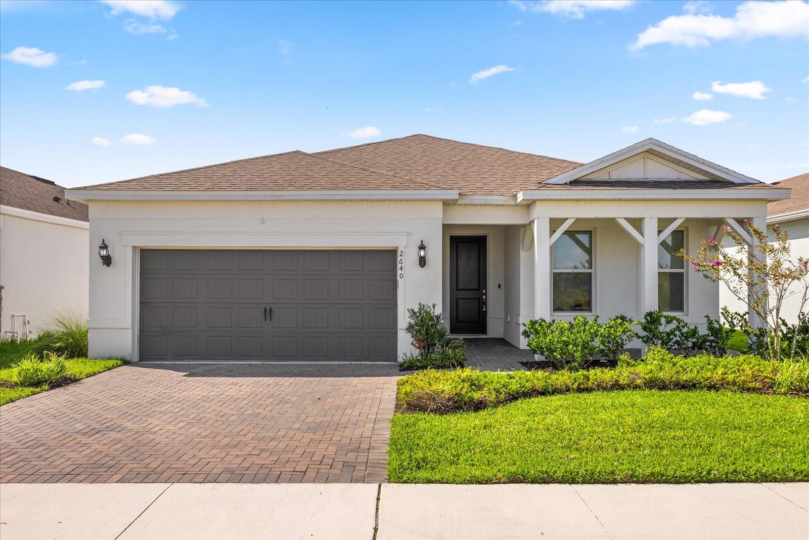 Welcome to your dream home in the vibrant Tohoqua community! This stunning 4-bedroom, 2-bathroom single-family residence offers over 2,000 square feet of open-concept living space, perfect for both relaxation and entertaining. Built in 2022, the home features a spacious gourmet kitchen with quartz countertops, 42” soft-close cabinetry, stainless steel appliances, and a large center island. The bright and airy living and dining areas flow seamlessly to a covered lanai overlooking a fully fenced backyard—ideal for outdoor gatherings. The private owner’s suite boasts a walk-in closet and a spa-inspired bathroom with dual sinks and a frameless glass shower. With ceramic tile throughout the main living areas, a 2-car garage, and no rear neighbors, this home offers both style and comfort. Enjoy resort-style amenities including a clubhouse, pool, fitness center, tennis courts, playgrounds, and scenic walking trails. Located just minutes from Lake Nona, the Turnpike, shopping, dining, and top-rated schools—this home has it all!