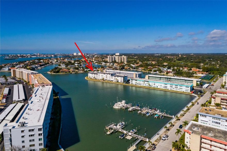 Your Tropical Paradise Awaits! Step into your sun-soaked sanctuary—a beautifully UPDATED, TOP-FLOOR WATERFRONT CONDO with sweeping VIEWS OF BOCA CIEGA BAY waterways and the marina. This deluxe 2-bedroom, 2-bath retreat (1,250 sq ft) is designed for effortless coastal living, featuring a spacious OPEN FLOOR PLAN, SPLIT BEDROOMS for privacy, and HURRICANE-IMPACT WINDOWS AND FRONT DOOR for peace of mind. Your dedicated CARPORT is just steps from the entrance, making every arrival a breeze. The chef’s kitchen is a tropical delight, boasting granite countertops, stainless steel appliances, a gas range, and a kitchen island perfect for gathering with friends. Enjoy cool porcelain tile underfoot and recessed lighting that sets the mood for island-inspired meals. Unwind in your airy Florida room with hurricane shutters on the impact windows, where you can watch dolphins play and boats glide by as gentle breezes drift in from the bay. This inviting space features a sleeper sofa and ample storage—ideal for hosting guests or simply relaxing with a good book. The grand living and dining areas are perfect for entertaining, with plush seating and electric recliners for ultimate comfort. Retreat to your primary suite with a walk-in closet, en-suite bath, and private slider to the Florida room. Both bathrooms are tastefully updated with granite counters and walk-in showers. This TURNKEY, FULLY FURNISHED condo is your gateway to paradise—where every day feels like a vacation. Welcome home to your tropical oasis!
Step outside to enjoy the heated waterfront pool, surrounded by lush tropical landscaping and views of the sparkling intracoastal waterway. Set up temporary chairs on the walkway for your own front porch experience or stroll to the community patio for sunset gatherings. Live the resort lifestyle with Town Shores amenities: dock and boat slips, fishing pier, kayak launch/storage, walking paths, four heated pools, shuffleboard, bocce, tennis and pickleball courts, RV and boat trailer parking, and a vibrant clubhouse with fitness center, saunas, billiards, ballroom, pool and library.
Downtown Gulfport exudes a vibrant, tropical vibe, where palm-lined streets lead you to the lively Beach Blvd entertainment district bustling with energy. Here, you can stroll through colorful monthly art walks, savor fresh seafood at charming restaurants and bars, and soak up the sun on the sandy shores of Boca Ciega Bay or cast a line from the scenic fishing pier. It’s a fun-filled destination that truly feels like paradise!
Just 11 minutes away, the sun-soaked shores of St. Pete Beach on the Gulf of Mexico invite you to dive into crystal-clear waters, enjoy thrilling water adventures, and sip tropical cocktails at lively beachside restaurants and bars. In just 13 minutes, you’ll find yourself in downtown St. Petersburg, where unique eateries, vibrant museums, and the spectacular pier create a one-of-a-kind atmosphere. Take a 23-minute trip to Ft. Desoto Park, a paradise of 1,136 acres filled with natural beauty and pure relaxation. For your next getaway, Tampa International Airport is an easy 29-minute drive, and if you’re feeling adventurous, set sail from Tampa’s port on a luxurious cruise ship bound for the Caribbean’s turquoise seas and sandy beaches.