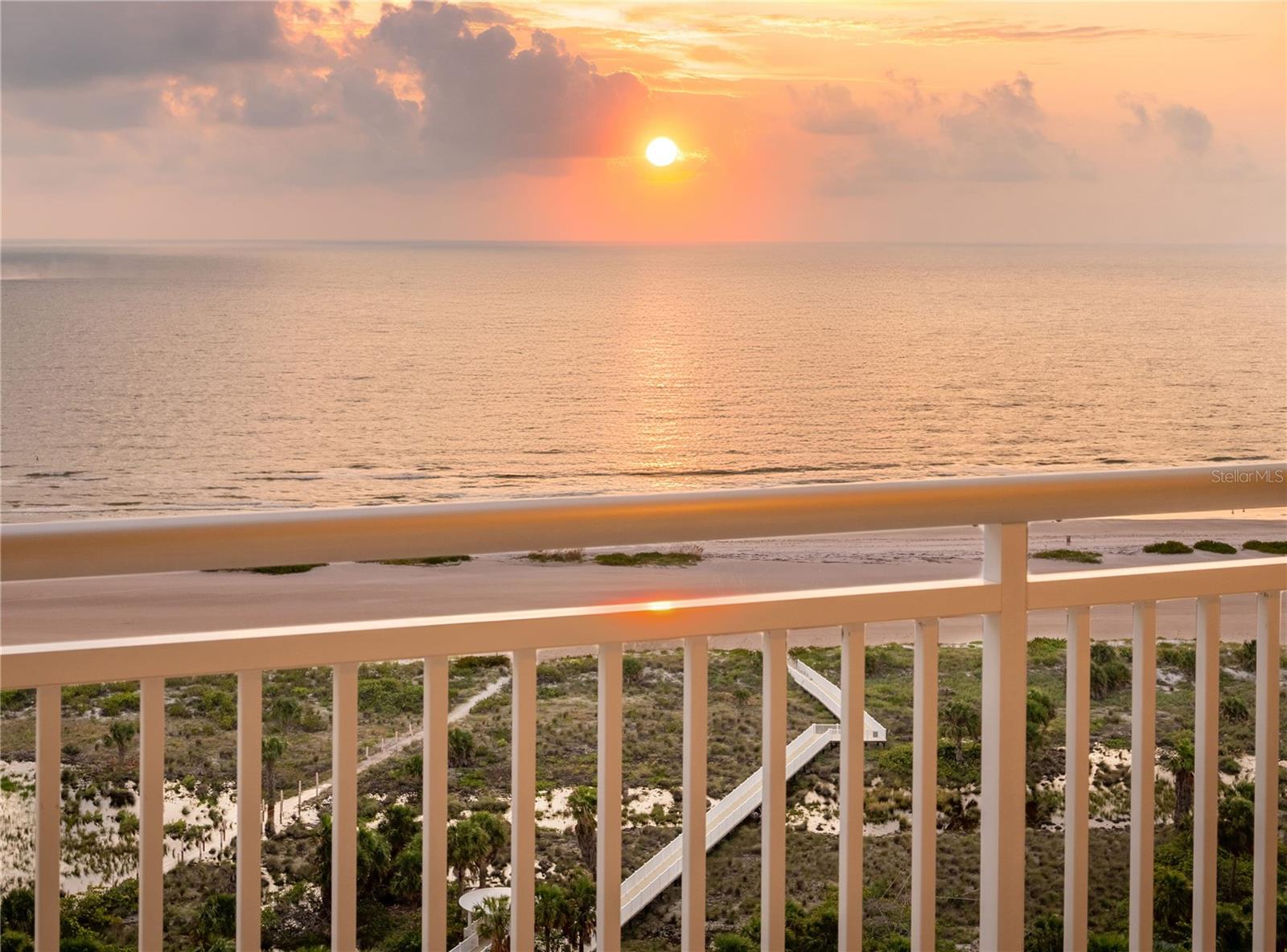 RARE 3 BED UNIT - 2 COVERED PARKING SPACES! Nestled within the impressive 14-acre gated Grande on Sand Key, this exquisite high-level condo on the 18th floor offers a refined living experience. The Vizcaya residence features 3 bedrooms (or 2 bed plus office) and 2.5 baths across 1,952 square feet of thoughtfully designed interior space, complemented by an additional 400 square feet of TWO TERRACES that provide captivating West and East views. **** Enjoy stunning GULF OF MEXICO VIEWS, and picturesque sunsets stretching across the western horizon as well as breathtaking vistas of Clearwater Harbor to the south and east. **** The interiors are designed with a timeless elegance, seamlessly integrating wood cabinetry, wood and stone flooring, and a soothing paint palette to create a cohesive and inviting atmosphere. The stylishly upgraded BUILT-IN BAR area is highlighted by elegant brick wall decor. This contemporary design not only enhances the aesthetic appeal but also adds a touch of sophistication to your entertaining space. **** The property is equipped with BRAND-NEW hurricane-rated double-pane SLIDING GLASS DOORS, offering superior protection and energy efficiency. These doors are designed to withstand severe weather while enhancing your home's safety and insulation. **** NEW AC HVAC - installed October 2021.**** The third bedroom is being used as an office currently, it boasts newly installed built-in shelving featuring elegant granite countertops. This addition provides a functional workspace, enhancing the room's versatility and appeal. (This room can easily accommodate a queen bed and 3rd sleeping room solution.) **** Rare 2 ASSIGNED PARKING SPACES convey - Under building parking space, and carport space by the tennis court. Storage locker also conveys with the sale of this unit. **** The building has recently undergone MAJOR RENOVATIONS which include: New building envelope paint and seal, all windows caulked and resealed, New expansion joints put in, New water barrier put on, All planters resealed, Brand new landscaping. New security gate all around the property. **** New added GATED ACCESS from the amenities deck to the Sheraton nearby if you want to hop over next door to for a snack at the Poolside Cafe or drinks at Slo Joe's Turtle Bar. **** The amenities are wholly reminiscent of a WORLD CLASS RESORT with multiple pools, tennis courts, social rooms, canopied poolside cabanas, fitness centers with steam and sauna and last, but certainly not least 24 HOUR GUARD GATED security and concierge services (Concierge Mon-Fri).