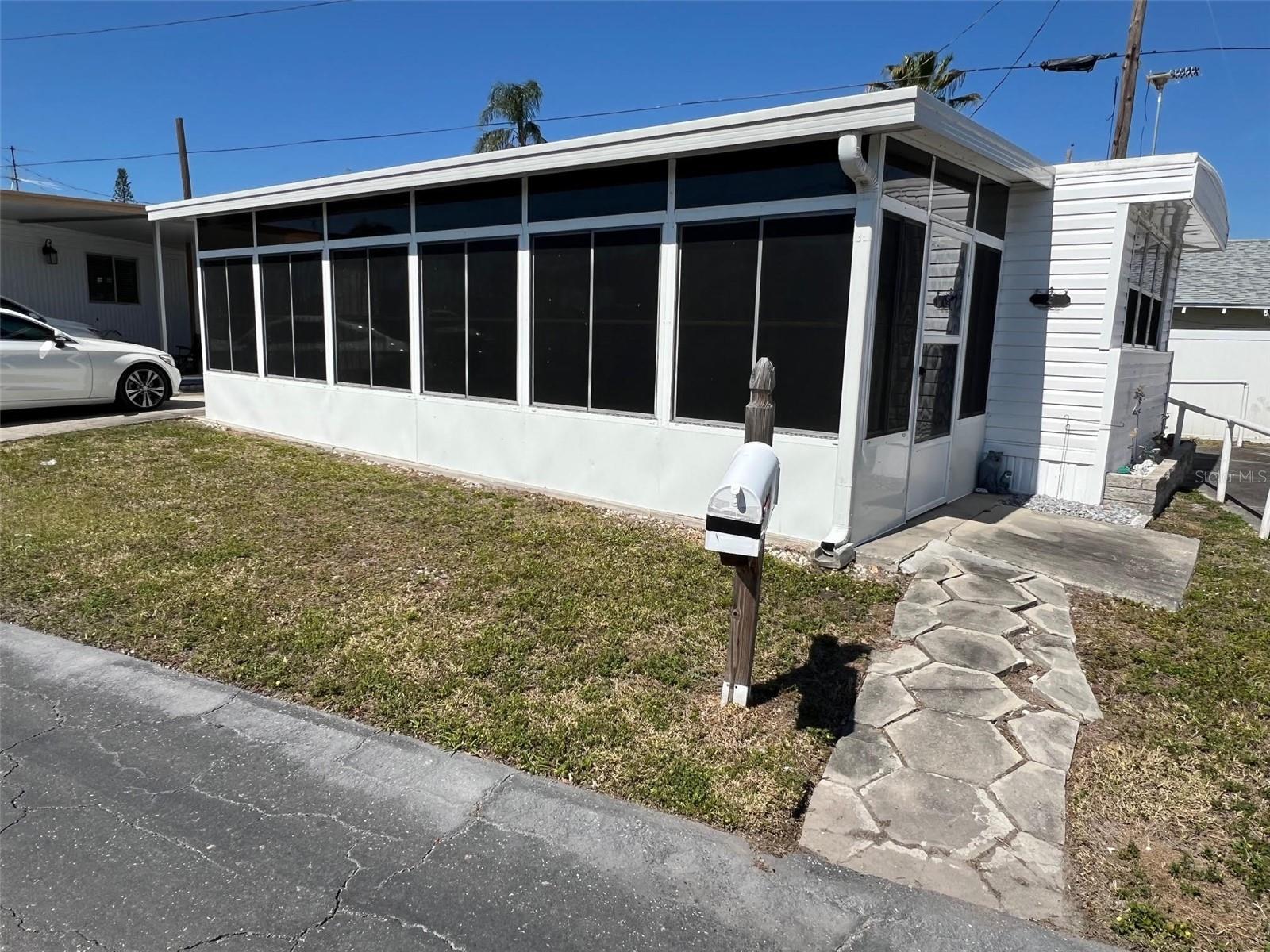 Positioned adjacent to the clubhouse in the welcoming Oasis Mobile Home Park, this charming residence offers a wonderful opportunity for those seeking a peaceful yet social 55-plus community. With one of the most affordable maintenance fees in Pinellas County at just $143.00 per month, residents benefit from included water, sewer, garbage, and lawn care services. This home allows for up to two indoor cats.
INTERIOR:
This fully furnished ( the seller will be removing a few items-a list will be provided) one-bedroom, one-bathroom home provides an inviting atmosphere, with an attentively designed interior featuring a sofa sleeper in the living room for overnight guests. Great use of space! Recent touches enhance the space, including updated doors, refreshed light colored paneling, and an updated kitchen outfitted with sleek stainless-steel appliances, plenty of cupboards , closet, a disposal, and long-lasting laminate flooring that extends through most of the home. A walk-in closet in the bedroom provides abundant storage, while the ensuite bathroom is designed for efficiency by including vinyl tile flooring, a tub, and a shower.
EXTERIOR
On the exterior, vinyl siding increases resilience, while the lowered Florida room extends the living area, creating a versatile sanctuary. Additionally, the roof-over construction contributes to longevity and protection. Priced at $70,000 with the share included, this property presents an excellent opportunity to personalize and create a home that reflects individual style and preferences. Call today for your private showing!