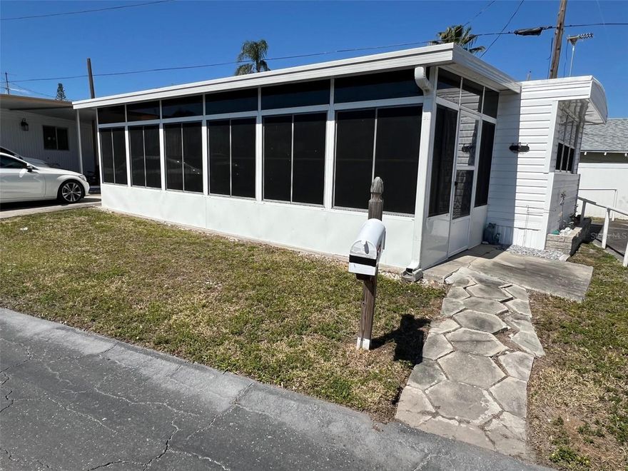 Positioned adjacent to the clubhouse in the welcoming Oasis Mobile Home Park, this charming residence offers a wonderful opportunity for those seeking a peaceful yet social 55-plus community. With one of the most affordable maintenance fees in Pinellas County at just $143.00 per month, residents benefit from included water, sewer, garbage, and lawn care services. This home allows for up to two indoor cats.  
INTERIOR:
This fully furnished ( the seller will be removing a few items-a list will be provided) one-bedroom, one-bathroom home provides an inviting atmosphere, with an attentively designed interior featuring a sofa sleeper in the living room for overnight guests.  Great use of space!  Recent touches enhance the space, including updated doors, refreshed light colored paneling, and an updated kitchen outfitted with sleek stainless-steel appliances, plenty of cupboards , closet, a disposal, and long-lasting laminate flooring that extends through most of the home.   A walk-in closet in the bedroom provides abundant storage,  while the ensuite bathroom is designed for efficiency by  including vinyl tile flooring, a tub, and a shower.
EXTERIOR
On the exterior, vinyl siding increases resilience, while the lowered Florida room extends the living area, creating a versatile sanctuary. Additionally, the roof-over construction contributes to longevity and protection. Priced at $67,999 with the share included, this property presents an excellent opportunity to personalize and create a home that reflects individual style and preferences.  Call today for your private showing!