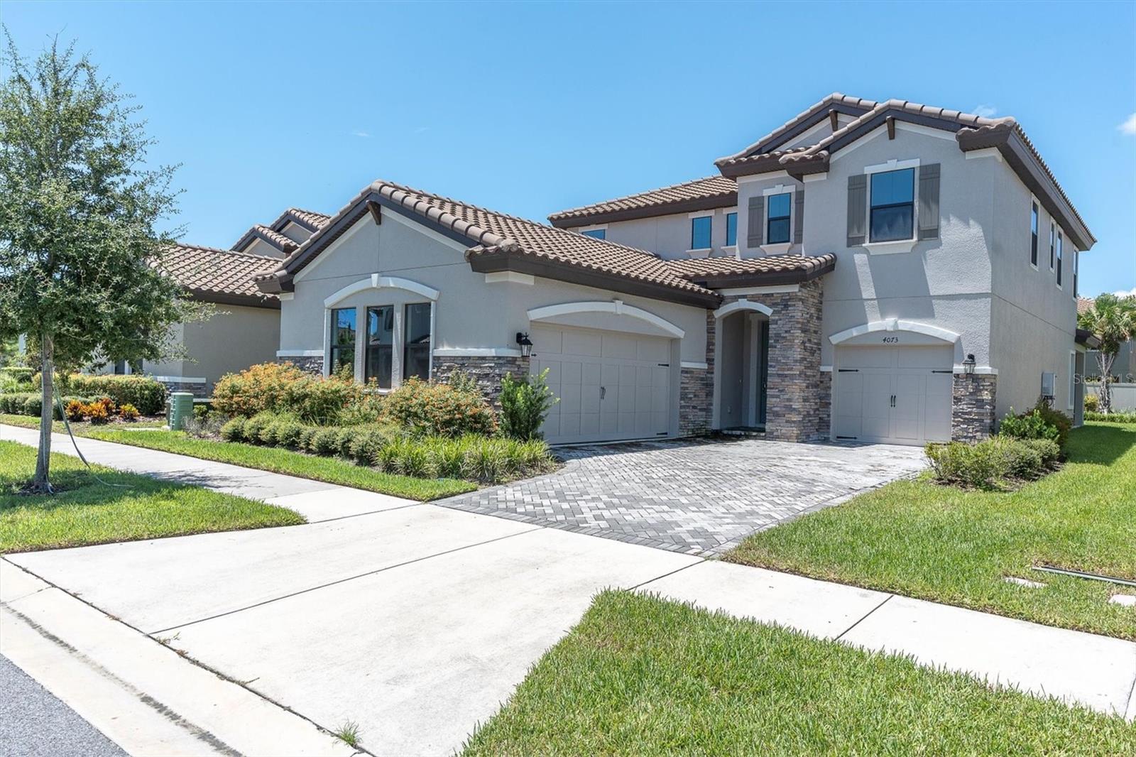One or more photo(s) has been virtually staged. This stunning 4-bedroom, 3-bath Ballast Point floor plan in Starkey Ranch was built in 2022 and has never been lived in—offering the rare opportunity to own a nearly new home without the wait of new construction. With thoughtful upgrades and stylish design throughout, this home delivers the perfect blend of comfort, function, and elegance in one of Tampa Bay’s most sought-after communities. Step inside to discover a bright, open-concept layout with durable luxury vinyl plank flooring throughout the main living areas (excluding the downstairs bedroom). 8-foot doors and natural light enhance the home’s spacious feel.The gourmet kitchen is a dream—featuring quartz countertops, stainless steel appliances, subway tile backsplash, a large single-basin sink, butler’s pantry, and a walk-in pantry. The large center island opens to the family room and oversized dinette area, with sliding glass doors leading to the covered lanai. A pocket office just off the kitchen adds functionality for remote work or daily organization. The first-floor bedroom includes a walk-in closet and adjacent full bath with a walk-in shower—ideal for guests or multigenerational living. You’ll also find a den/office with double glass doors offering flexible use. Upstairs, a spacious loft provides a second living area. Two bedrooms share a bathroom with double sinks, while the primary suite offers a luxurious ensuite bath with dual vanities, garden tub, walk-in shower, and an oversized walk-in closet. The upstairs laundry room includes a sink and convenient access from the primary suite. Extra storage is available with a closet under the stairs. Additional features include:Split 3-car garage, Tankless water heater, Two separate A/C units and a backyard fenced on two sides, with space to add a pool or extend the patio. As a resident of Starkey Ranch, you’ll enjoy access to community pools, parks, playgrounds, dog parks, top-rated schools, scenic trails, and year-round events. This home is truly move-in ready—schedule your showing today and take advantage of this rare opportunity in Starkey Ranch!
