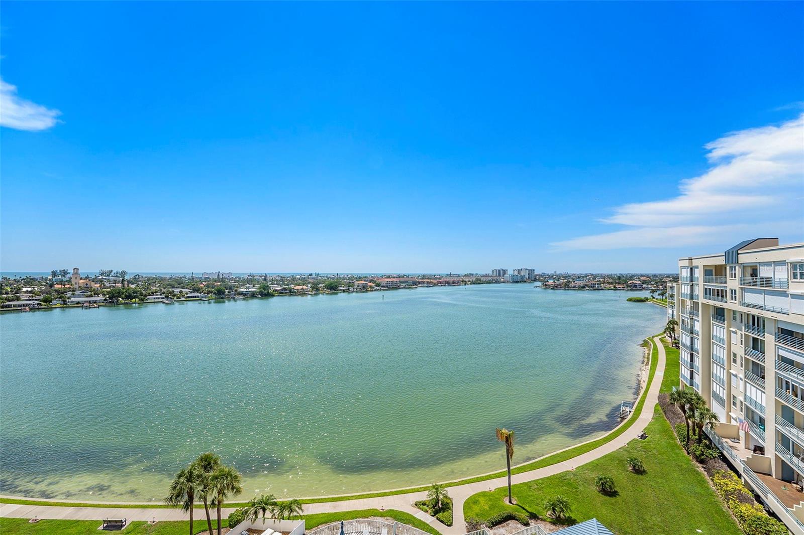 Beautiful 8th floor penthouse corner unit condo with incredible views of the Gulf, the Intracoastal, and downtown St Petersburg!!! This 2 bedroom, 2 bath, condo with an office has been completely renovated from top to bottom including new travertine tile floors, vinyl wind rated windows and sliders (with a transferable lifetime warranty), updated electrical, updated plumbing (including a tankless hot water heater), and new A/C. The walls between the main living area and kitchen were removed giving a great open floor plan, an expanded kitchen area, lots or natural light, and stunning views in every direction. The kitchen remodel features lots of custom cabinet space, beautiful quartz countertops, high end black stainless steel appliances, and an area set up for dual home offices. You can enjoy the sunset from the attached balcony or your bed in the primary suite featuring a fully remodeled bathroom with an oversized shower, dual sinks, and a walk in closet with custom shelving. Don't forget the guest bedroom, second fully remodeled full bathroom, or the large office with a murphy bed . You can start your day with coffee and sunrises on the front balcony, spend your afternoon enjoying the gated community amenities including waterfront walking trails , swimming pools, a wood shop, tennis and pickleball courts, and finish up your day with drinks, diner, and a sunset over the gulf on your rear balcony. Don't forget all the amazing restaurants in St Petersburg, the beautiful beaches, and shopping all within minutes of home.