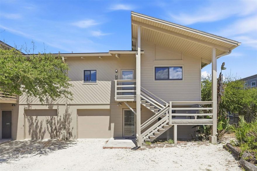 Welcome to your slice of coastal paradise in New Smyrna Beach! Sea Dues - Dolphin offers this rare and unique property as part of an intimate beachfront community on the NO DRIVE beach.  The Dolphin community is 10 townhomes set along the beautiful Atlantic Ocean.  The second floor features a bright, open-concept design with a spacious living and dining area, an open kitchen, and two generously sized bedrooms—each with its own en-suite bath. The Cathedral ceilings and beautiful cypress and pecky cypress wood paneling elevate this great room configuration.  Step out onto your private second-floor deck to enjoy ocean views and refreshing coastal breezes, creating the perfect setting for relaxing or entertaining. On the ground level, a versatile studio-style space offers its own open layout with a designated sleeping area, partial kitchen, and living space. Sliding doors lead to a private patio—ideal for guests, extended family, or additional living flexibility. A deep one-car garage provides added convenience for a vehicle, pool toys and storage. Perfectly positioned, the unit overlooks the community pool and includes easy access to the beach via a private walkway.  Whether you’re seeking a full-time residence, vacation retreat, or investment opportunity, this distinctive property delivers the best of effortless beachside living.  New main roof 2026.  New hardee board and weather stripping Spring 2025.  Impact windows(11) 2017.  Hot water heater 2024.  Deck refurbishment 2022.  New garage door 2021.  New interior doors 2020.  Primary bath renovation 2018.  HVACS 2022 & 2025