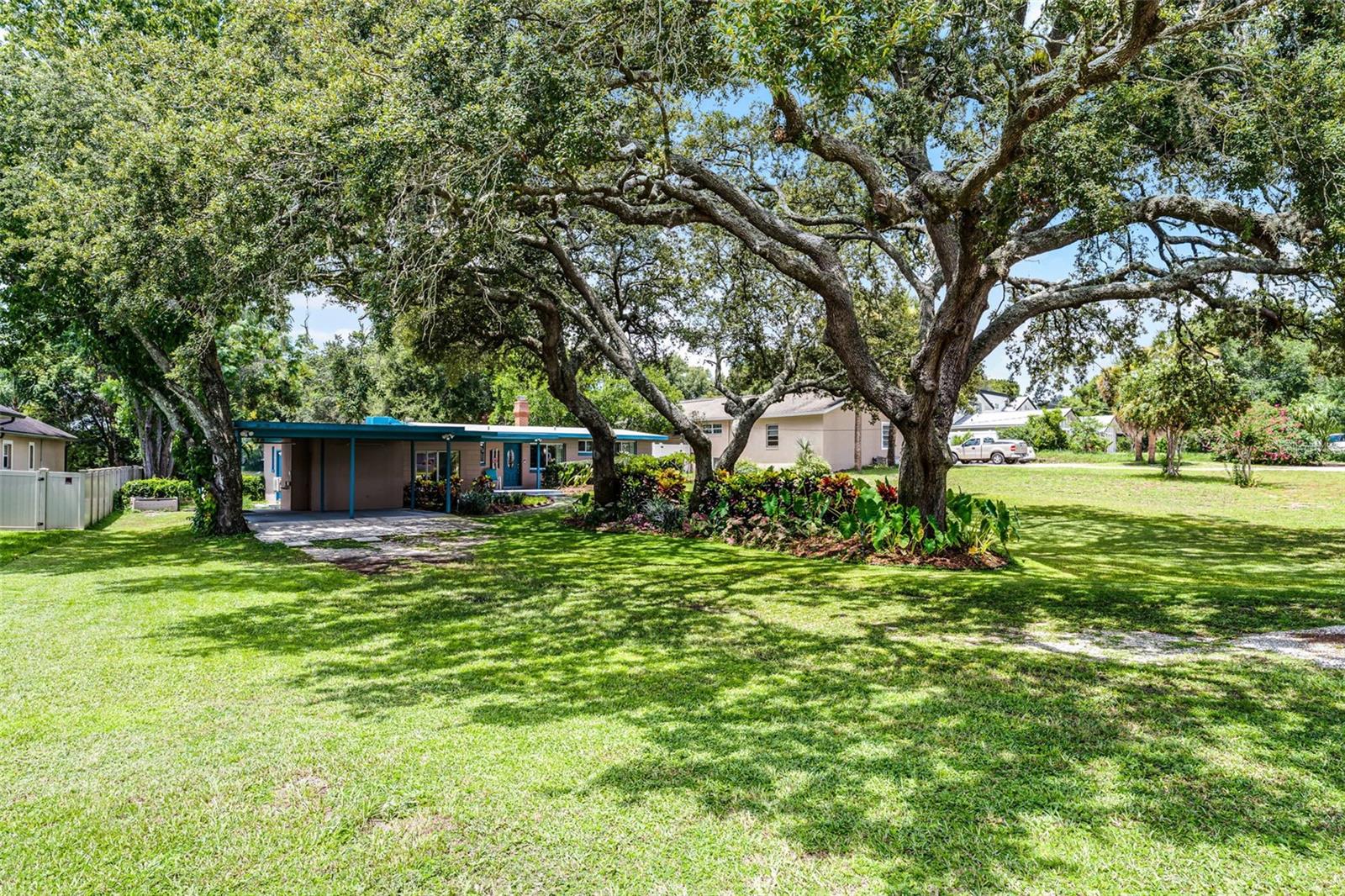 Waterfront home on Lake Crystal Bowl and with no HOA. Vintage 3 bedroom 2 bath ranch style home nestled on over 3/4 of an acre lot. As you drive up, you are greeted by sprawling oaks and delightful gardens, featuring colorful flowers, caladiums, and plumeria. You can see how the owner has lovingly tended this property. Upon entering you immediately notice the view straight out the back to the huge yard and water front at the end of the lot. This home has an open concept living area in the center, flanked to the left and the right by bedrooms. This creates the perfect split bedroom floor plan. There is a real stone fireplace with a real brick chimney. Some rooms feature terrazzo floors. The Primary suite is huge and has a large walk in closet. Primary bath has updates including LVP flooring. Most light fixtures and ceiling fans have been updated. There is a bonus/Florida room under heat and air on the back of the home. Also a classic design open patio encircled by a stone half wall leads to the back yard. The home features a two car carport with a short breezeway to the back yard and a small shed in the back yard for extra storage. Relax in front of serene waterfront views, enjoy local bike trails, or just do a little gardening. There is over 3/4 of an acre and separate spigots connected to reclaim water for irrigation. You are only minutes to schools, restaurants, shopping, and the Casselberry Golf Course.