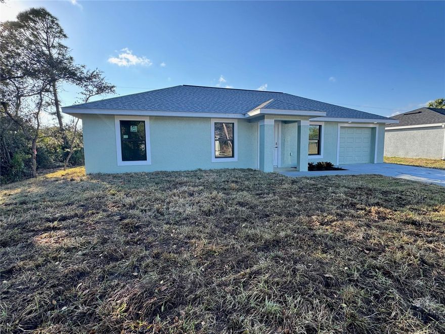 Get ready to fall head over heels for this absolutely adorable 3-bedroom, 2-bath home in Murdock, perfectly designed for the first-time buyer or seasonal visitors. This sweet abode welcomes you with tile flooring throughout, ensuring a clean and modern feel.  The home offers peace of mind with sturdy impact windows and doors, plus high elevation and X zone.  The heart of the home, its darling kitchen, which boasts granite countertops, charming wood cabinets with a soft-close feature, a lazy Susan, sleek stainless appliances, and a handy eat-in bar perfect for quick breakfasts or casual chats.  There is modern can lighting in both the kitchen and family room, and ceiling fans in every room.  You'll love the spacious walk-in closet and large shower in the primary suite. The washer and dryer are already included, making moving day a total breeze.  In the garage there is a handy utility sink along with a peg board in the garage for all your tools.  Though the sliding door there is a concrete pad already poured for a future lanai or just enjoying the large back yard. Come check out this sweet home.