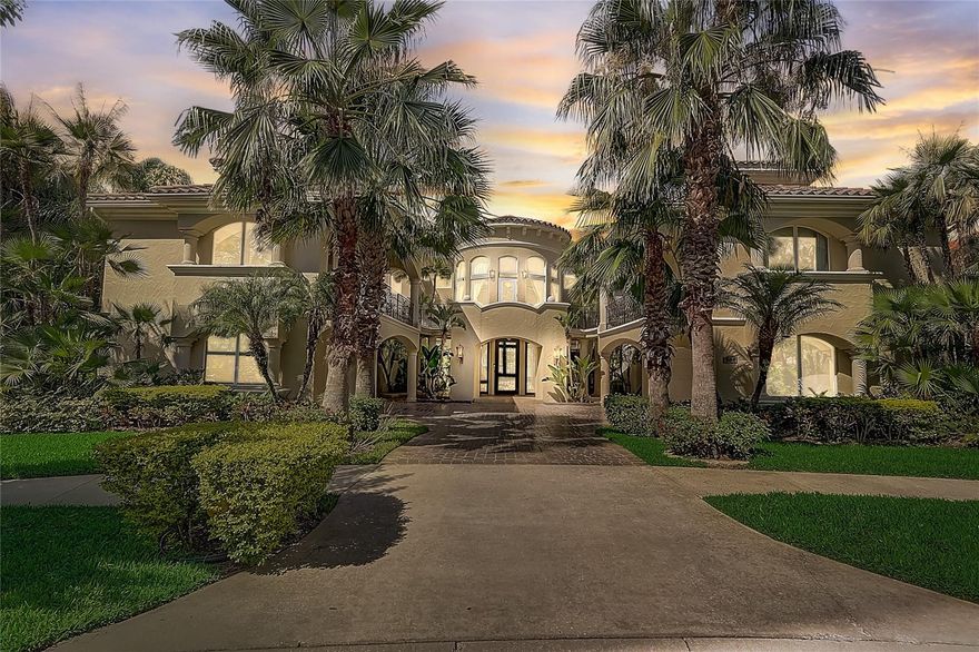 Experience the epitome of luxury living in this extraordinary lakefront estate, seamlessly blending timeless charm with contemporary elegance. Nestled along the pristine shores of crystal clear Spring Lake, this remarkable property offers a haven for  water sports enthusiasts and seaplane aficionados. As you approach, a grand brick drive adorned with majestic Royal Palms sets the stage for the grandeur that awaits.

Step into the 2 story entryway, where a breathtaking floating staircase takes center stage, capturing your attention with its stunning design. The circular centered vestibule beckons you into a thoughtfully designed layout, where the formal rooms seamlessly flow together in an open arrangement. Culinary enthusiasts will be delighted by the gourmet kitchen, a true chef's dream featuring top-of-the-line WOLF and SUB ZERO appliances, dual wine coolers, custom-built cabinetry, multiple sinks, and generously sized double working islands.

Effortlessly transition between indoor and outdoor living with the aid of triple sets of French doors that lead to the outdoor spaces. Throughout the family living areas, elegant stone flooring exudes a casual yet refined ambiance. The kitchen, nook, and family room unite in an open concept layout that harmoniously captures the breathtaking lake views. Step outside onto the expansive covered outdoor living area, designed to maximize the joys of lakefront living. Here, a sparkling pool and heated spa invite you to indulge in poolside relaxation, while ample seating, al fresco dining options, and a cozy fireplace provide the perfect ambiance for unwinding by the water's edge.

Retreat to the owner's haven, a spacious sanctuary thoughtfully designed with unrestricted luxury in mind. Boasting lavish amenities, including a sitting area and fireplace, the owner's retreat seamlessly connects to the outdoors, blurring the boundaries between nature and comfort. Indulge in the lap of luxury in the primary bath, featuring a private sauna and walk through shower, an opulent space exuding elegance at every turn. The closets are expansive and impeccably finished, offering ample storage for your personal belongings. It even has a custom built in coffee machine

You may ascend to the second story by the stairs or ELEVATOR! A family-style game room awaits, offering panoramic lake views that will captivate and inspire. For movie enthusiasts, the fully equipped home theater boasts state-of-the-art equipment, ensuring an unparalleled cinematic experience. 4 bedrooms on upper level are  generously proportioned and feature  en-suite bathrooms, along with private sitting or play areas for added convenience and versatility. GUEST SUITE above the garage has kitchenette and its own private entrance 

Elevating your entertainment options, the third level presents an awe-inspiring panorama as you engage in a friendly game of pool, taking in the incredible views that surround you.

This extraordinary lakefront estate is further enhanced by the addition of a brand new, STATE-OF-THE-ART DOCK, providing an unrivaled gateway to the water. A truly remarkable property where old-world elegance meets modern sophistication in perfect harmony