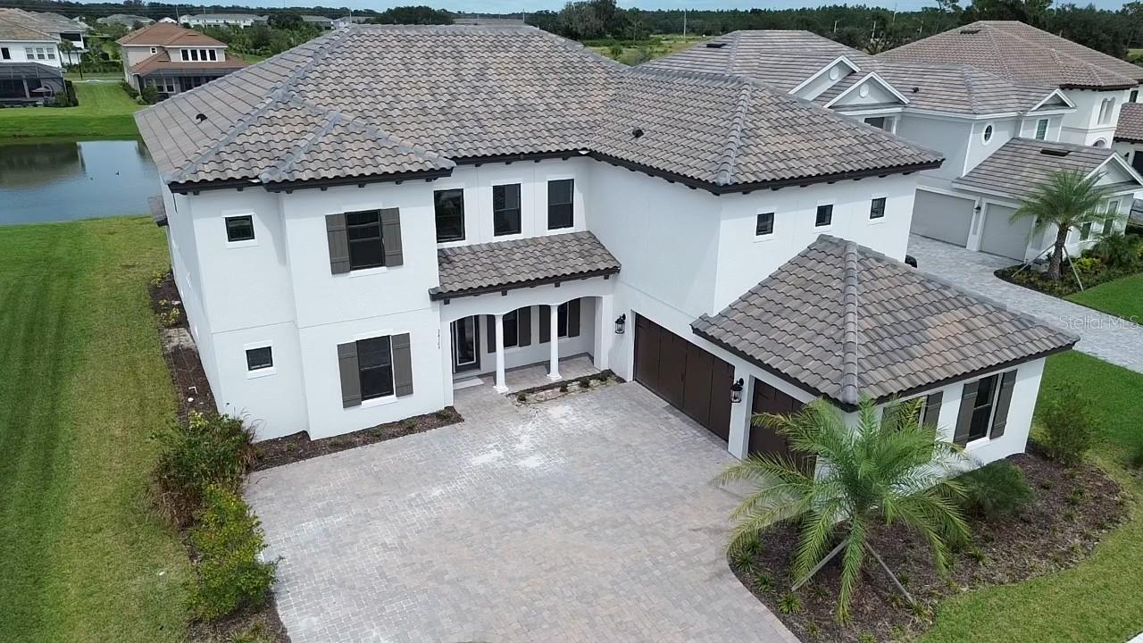 This Forthsyth model not only has the space, but a beautiful pond view and on a cul de sac road. Rivers Edge is a gated community offering a resort style pool, hot tub, fitness center, basketball, pickleball courts, and trails. This home is brand new and offers 5000 sq ft with 6 bedrooms, 5 1/2 bathrooms, Office, and Game Room. The first level has the primary room, office, bedroom with full bathroom, extended lanai, formal dining room, and a 20-foot-high open living room concept. The kitchen has all new stainless-steel appliance, gas cooktop, granite countertops, walk in pantry, and butler's pantry. The driveway is fully paved and has an extension for additional parking spots if needed. The upstairs has a game room with 1/2-bathroom access, porch access, and wet bar! This community is located near I-75, restaurants, Wiregrass Mall, Tampa Premier Outlets, major roads, and more! This home is near 3 major hospitals (Advent Health, Orlando Health, and Baycare) making it perfect for any job relocations in the area.