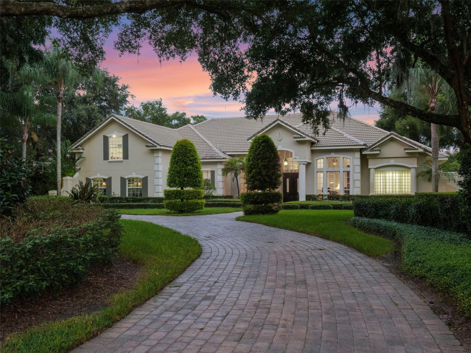 Experience gated estate living in the prestigious Lake Markham Preserve, a 24-hour guard-gated community. This nearly 5,000-square-foot residence is set on a full acre and offers a rare combination of privacy, luxury and lifestyle with a private tennis court, resort-style pool and expertly upgraded interiors. Inside, travertine and hardwood floors flow beneath soaring coffered ceilings, leading to a chef’s kitchen equipped with Sub-Zero refrigeration, gas cooktop, built-in icemaker, new LG oven and microwave, and an expansive walk-in pantry. The remodeled primary suite features motorized blinds, quartz countertops, a spacious walk-in closet, and a luxuriously appointed bath with a frameless glass shower and statement soaking tub, delivering a spa-like experience. An executive home office offers a refined space for work or study, while the home’s layout includes four en-suite bedrooms and a spacious upstairs bonus room with its own full bath and walk-in closet, offering flexibility as a fifth bedroom, guest retreat, or media room. Private. Elevated. One of a kind.