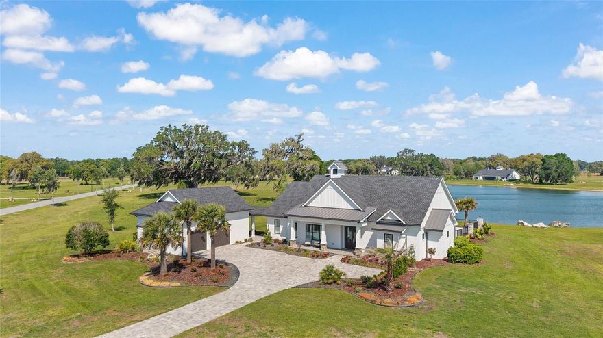 Welcome to Bel Lago, one of Marion County Florida’s best kept secrets! Offered for your consideration is a thoughtfully crafted custom 3-2-1 home. Situated lakefront on 1.25 acres and backing up to the Halpata Taskanaki Preserve, part of the Florida Greenway and approximately 8,000 acres offering unmatched privacy and peaceful surroundings. This home built in 2024, is practically brand new, designed with both luxury and efficiency in mind, the home showcases quality and comfort. The open concept layout is complimented by features such as custom electric shades, whole house water filtration, 2 tankless water heaters, security system, reverse osmosis filter in kitchen, linear fireplace and porcelain tile throughout, and so much more . Stepping through the glass doors the home also features custom fence around the salt water pool with a view overlooking the stocked lake, enjoy hours of peaceful enjoyment and relaxation.  Additional feature is an oversized garage, connected by a breezeway you will find a staircase leading above the garage to an unfinished area just waiting to be a man cave, game room, or whatever finishing touch you may have in mind.   Bel Lago is located just minutes from shopping, hospitals and dining as well as 20 minutes to the World Equestrian Center, & 1.5 hrs to Orlando .  Bel Lago is more than just a community, known for its extensive multi use trail system, and abundance of wildlife, and close proximity to Ocala, Bel Lago makes living here what you deserve and many desire.  Come see for yourself and prepare to be amazed.