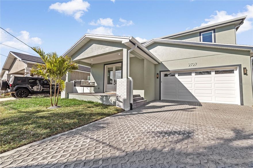 NEW premium built home on a quiet, charming brick street in the heart of Old West Tampa! Equipped With Natural GAS for big Energy savings.  Construction HAS just been completed, ready for YOU! This home blends traditional architectural charm with modern functionality. The open-concept floor plan is filled with natural light, tile flooring, high ceilings, and a spacious layout ideal for daily living and entertaining. The gourmet kitchen offers quartz countertops, stainless steel appliances, custom cabinetry with underneath lighting, and a large island overlooking the dining and living areas. The primary suite boasts a spa-like en suite bath with double vanities, an oversized shower, and his/her walk-in closets. A private, downstairs addition guest suite with its own full bath, and oversized walk-in closet. Next, the two additional bedrooms provide flexibility for family, guests, or a home office with easy access to the bathroom, which meets in the middle of each bedroom. THIS HOME FEATURES: Two-car garage, hurricane impact windows, energy-efficient systems, premium tile throughout the home, oak finished cabinetry, a creatively large laundry room which includes a mini kitchen so you have the options of having coffee or a night cap without heading to the downstairs kitchen. Enjoy your morning coffee on the covered front porch or entertain in the fenced backyard. This is The most central you can live in Tampa. Perfectly located just minutes from UNIVERSITY OF TAMPA (2 miles), Armature Works (1 mile), Tampa Riverwalk(1 mile), Downtown(2 miles), Midtown(2 miles), Raymond James (2 miles), and major interstates. Schedule your private showing today!