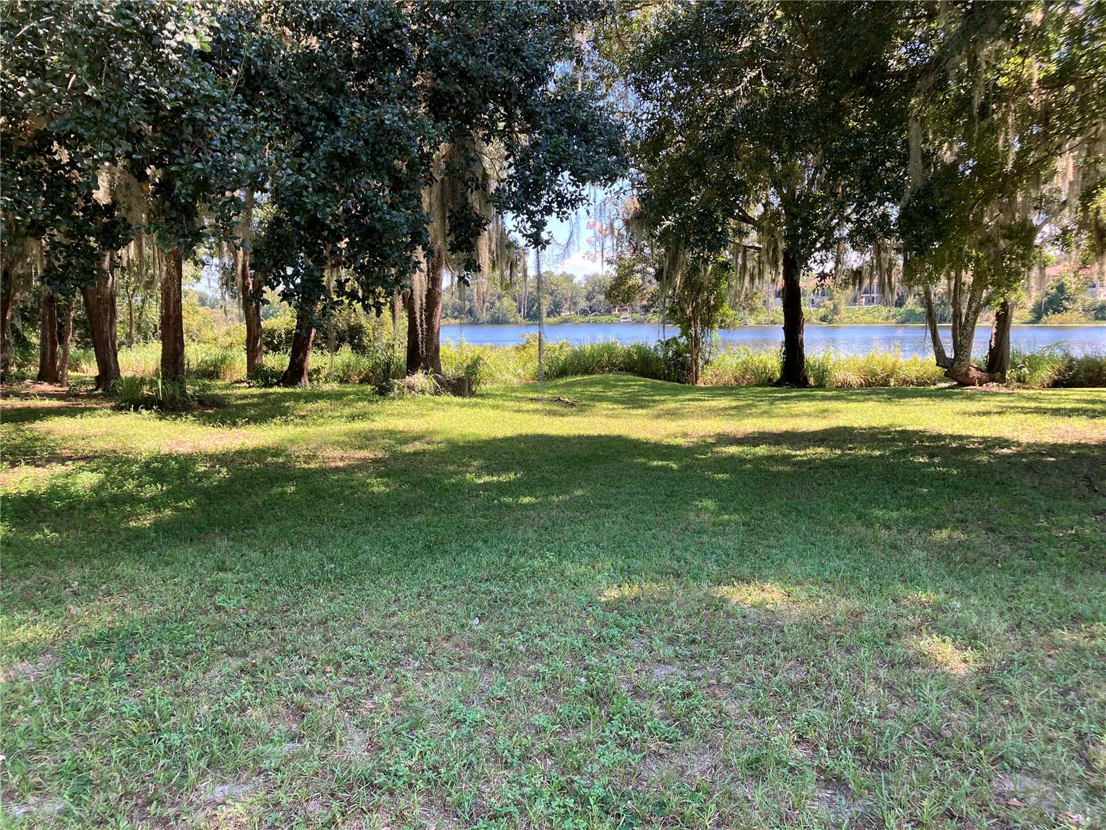 Beautiful subdivision Lakes of Deland welcomes you to build your next home on this mostly cleared waterfront lot on Horseshoe Lake. A few oak trees remain, but center of lot is cleared. Enjoy the nice breezes over the water in this 20 year old community. No gas powered boats allowed on lake but you may have battery operated or canoes. Take afternoon walks on the paved walking trail throughout the gated 55+ community. No feasibility studies have been done yet for this lot, but survey (see pics) was done over 10 years ago by Efird Surveying in Orange City. Front of lot measures 61 feet wide, while back (waterfront) is 82 feet. Depth is 117 on one side and 118' on other. Almost 1/4 acre lot in community of nice larger homes with tile roofs. HOA is $110 /month.