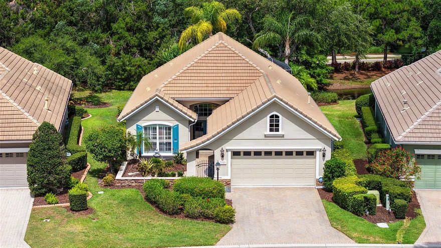Located in the highly desirable community of Lakewood Ranch, this beautifully appointed Neal Burgundy floor plan blends timeless elegance with effortless Florida living. Showcasing a stunning Country French stone elevation, welcoming courtyard with fountain, and tranquil private lake views, this 3-bedroom, 2-bath residence offers 2,224 square feet of thoughtfully designed living space with an in-ground heated spa and exceptional upgrades throughout.
Step through double glass French front doors into an elegant foyer featuring square columns with applied molding, coffered ceiling with crown molding, and rich architectural detailing that continues throughout the home. Ceramic tile flooring flows through the main living areas, while elegant hardwood flooring enhances the den and owner’s retreat. The spacious den, accessed through double doors, provides the perfect flex space for a home office or media room.
Designed for both everyday living and entertaining, the gourmet kitchen is a chef’s dream featuring KitchenAid stainless steel appliances including a dual-fuel gas cooktop with double electric ovens, built-in microwave, refrigerator, and under-counter wine cooler. Gorgeous new quartz countertops, designer glass tile backsplash, staggered cabinetry, under-cabinet LED lighting, recessed lighting, vaulted ceiling, and glass block accents create a bright and sophisticated culinary space.
The inviting living room showcases a masterfully crafted custom built-in with shelving and designer speaker-style cabinetry, while crown molding, decorator niches, and refined finishes add warmth and character throughout. Both guest bedrooms, privatized by pocket door, feature luxury vinyl flooring and custom closets.
The serene owner’s retreat offers a bay-style sitting area, private lanai access, and coffered ceiling with crown molding. The spa-inspired primary bath features designer tile, jetted soaking tub, spacious walk-in shower, dual vanities with quartz countertops and undermount sinks, porcelain tile flooring, linen closet, and extensive storage.
Outdoor living is equally impressive with a peaceful lakefront setting, heated spa, electric awning for sunset enjoyment, and inviting lanai designed for year-round relaxation. Additional highlights include plantation shutters, central vacuum with kitchen sweep, exquisite lighting and fans, new epoxy garage flooring, laundry room with sink and new washer and dryer with portable counter, mounted den TV, and a new A/C installed in November 2023.
This exceptional home combines luxury, comfort, and timeless style in one of Lakewood Ranch’s most sought-after settings.