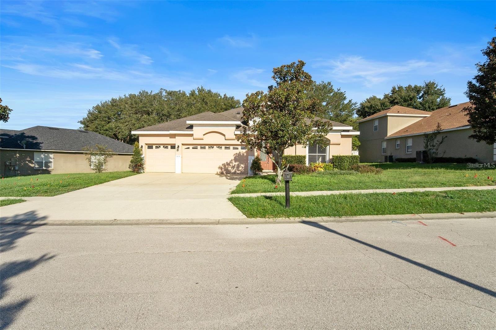 Welcome to this move-in ready 4-bedroom, 3-bathroom home in the sought-after Kensington Manor community! This home offers a contemporary open-floor plan, perfect for entertaining or enjoying family movie nights. Freshly painted with new large tile flooring, this home exudes modern elegance. The gourmet kitchen features granite countertops, 42" cabinets, and plenty of space for cooking and family meals. The split-bedroom floor plan provides privacy, with the master suite boasting a walk-in closet and an en-suite bath for your personal retreat. Relax and unwind on the covered and screened lanai, complete with patio furniture for your convenience. The multiple-car garage ensures ample parking, and the included washer, dryer, and lawn service make this a low-maintenance dream home. For families, the location is ideal—just a short walk from the community pool and playground, offering fun for all.The home is near highly rated schools and the beautiful West Orange Trail, where families can enjoy outdoor activities like biking, walking, and nature exploration. With AdventHealth Apopka and other healthcare services nearby, your family's needs are always covered. Commuting is a breeze with easy access to major highways, including the Turnpike and 429, leading to family-friendly entertainment such as Disney, SeaWorld, and the Orlando Science Center. This smart home, fully wired for ADT security, blends luxury with convenience in a family-friendly community. Schedule your tour today!