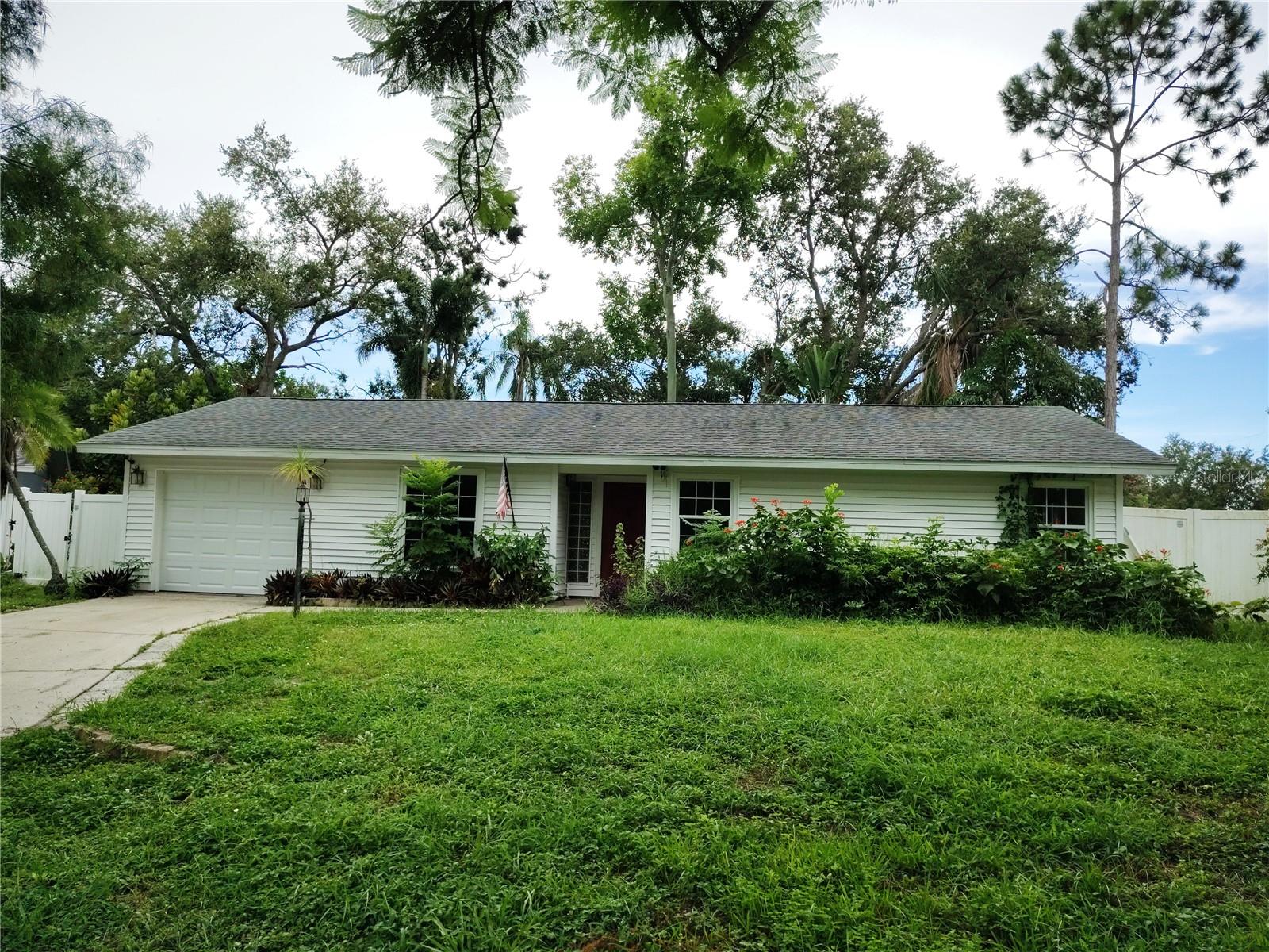 INVESTOR ALERT! Blank slate ready for renovation and a lot of the demo has already been done for you! Spacious floor plan featuring a large living room with vaulted ceiling and built-in shelving. Good floor plan with easy flow into the dining room. The primary bedroom boasts a full ensuite. There are two additional bedrooms with nice sized closets. Sliding glass doors in the dining room and main bedroom lead out to a patio and lushly landscaped and secluded back yard. Huge quarter acre lot!! Large one car attached garage plus additional driveway parking. Flowering trees and plants make for an inviting tropical oasis. Lots of privacy. Dead end private road with just five houses and no HOA. Garage door replaced and exterior siding added in 2021 according to permits. Roof replaced in 2016. Prime location approximately 3.5 miles to downtown Sarasota. SRQ airport is about 5 miles away and Lido beach is just an 8 mile drive. Convenient public transportation is on the corner and a grocery store, post office outlet, tavern and pizza place are just 2 blocks away! Perfect property for a DIY or HGTV enthusiast to re-do this home and make it their own. Almost all flooring has already been removed. Kitchen has been taken out. HVAC is not operational. AS IS contracts with no financing contingencies only. Priced to sell. Hurry - opportunity is knocking! HIGHEST AND BEST OFFERS REQUESTED BY SATURDAY, JULY 19, at 5:00 p.m. EST.