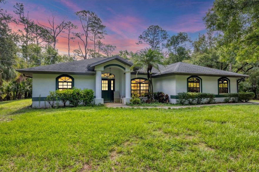 Discover your private slice of paradise in North Port Estates! Nestled on 3 wooded acres, this beautifully maintained home offers privacy, space, and versatility—perfect for those seeking a rural lifestyle without sacrificing convenience. Built by Tenbusch Homes in 2000, this 3 bedroom, 2 bathroom POOL HOME offers over 2000 square feet of living space, an oversized 2-car garage, and a thoughtful floor plan designed for both everyday living and entertaining. Step through the double door entry into a spacious layout featuring a split-bedroom design, ensuring privacy for your guests and family members. The large kitchen offers solid wood cabinetry, quartz countertops, a pantry, and a breakfast bar that opens to a sunny breakfast nook. The kitchen flows seamlessly into the family room, highlighted by a striking stone wood-burning fireplace, perfect for cozy evenings at home. Additional living areas include a formal dining room and formal living room, both finished with low-maintenance vinyl flooring, while the kitchen and main living areas are finished in tile. All three bedrooms are generously sized, and both guest bedrooms feature walk-in closets. The 25x13 primary suite offers dual walk-in closets and a spacious en-suite bath with dual vanities, a jetted garden tub, and a walk-in shower. Whether you're relaxing indoors or entertaining outdoors, this home was made to impress. Step outside and enjoy your screened saltwater pool, complete with a brand-new pool cage installed in 2023. An outdoor shower adds a resort-style touch, while the backyard offers room to roam, play, or garden. A detached shed with running water and electric adds functionality and extra storage. Additional updates include: AC system replaced in February 2025, Roof replaced (2016), drain field replaced approximately 5 years ago, new water softener and reverse osmosis system (2024). Best of all, the property is not located in a flood zone, offering peace of mind year-round. With Agricultural zoning, you can fully embrace country living. Bring your horses, start a garden, or raise chickens, all while being just minutes from I-75, shopping, dining, Gulf beaches, and area parks. If you’ve been dreaming of space, privacy, and the freedom to live your way, this North Port gem is calling you home.
