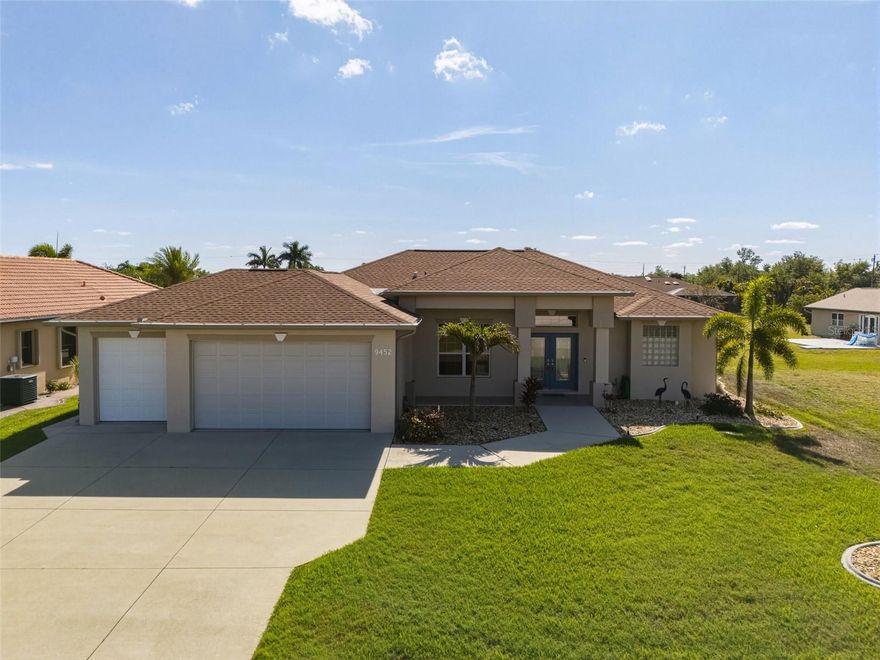 SOUTH GULF COVE! Impressive 3 bedroom + office, 2.5 bath, 3-car garage waterfront pool home with powerboat access to Charlotte Harbor leading to the Gulf! 80’ of rip rap seawall, 240sf dock with fish cleaning station, water, electric, 10,000 lb. lift plus tiki hut with true eastern exposure to enjoy the sunrise. Step outside to a covered lanai with convenient outdoor bath, beautiful concrete stamped deck and screened heated pool with cocktail table and jets making this a great space for entertaining. Many updates include new roof in 2022, new gutters and pool cage in 2023, garage floor epoxy in 2024 and new lanai deck, rip rap seawall and pool resurfaced with pebble tec in 2025 plus impact windows and accordion shutter on lanai provide additional peace of mind. Step inside double glass entry to 2,152 sf of living area featuring high ceilings, separate office, living room with large pocketing slider to seamlessly blend indoor/outdoor space and tile flooring in main living area. Updated kitchen features solid wood Kraftmaid cabinetry, granite counters, stylish backsplash, stainless appliances and breakfast bar overlooking dining area with built-in bar and beverage cooler and leading into family room with French doors to lanai and pool. Split floor plan provides privacy for all offering a generous primary suite with access to pool and private bath with dual sinks and Roman shower plus the two guest bedrooms feature wood flooring and share separate full bath. Nicely landscaped exterior plus 3rd car garage opens to backyard with concrete pad for additional storage and convenience. This home has been meticulously maintained with pride in ownership and is a true gem! Great location in the desirable South Gulf Cove community offering a voluntary HOA with access to a clubhouse for special events, four nearby parks, including South Gulf Cove Park with its own boat ramp, and close proximity to fine dining, shopping, top-rated schools, and numerous golf courses. Outdoor enthusiasts will love the easy access to boating, fishing, and the stunning beaches of Boca Grande, Don Pedro Island, and Manasota Key, all just a short drive away. Don’t miss this incredible opportunity—schedule your private showing today!