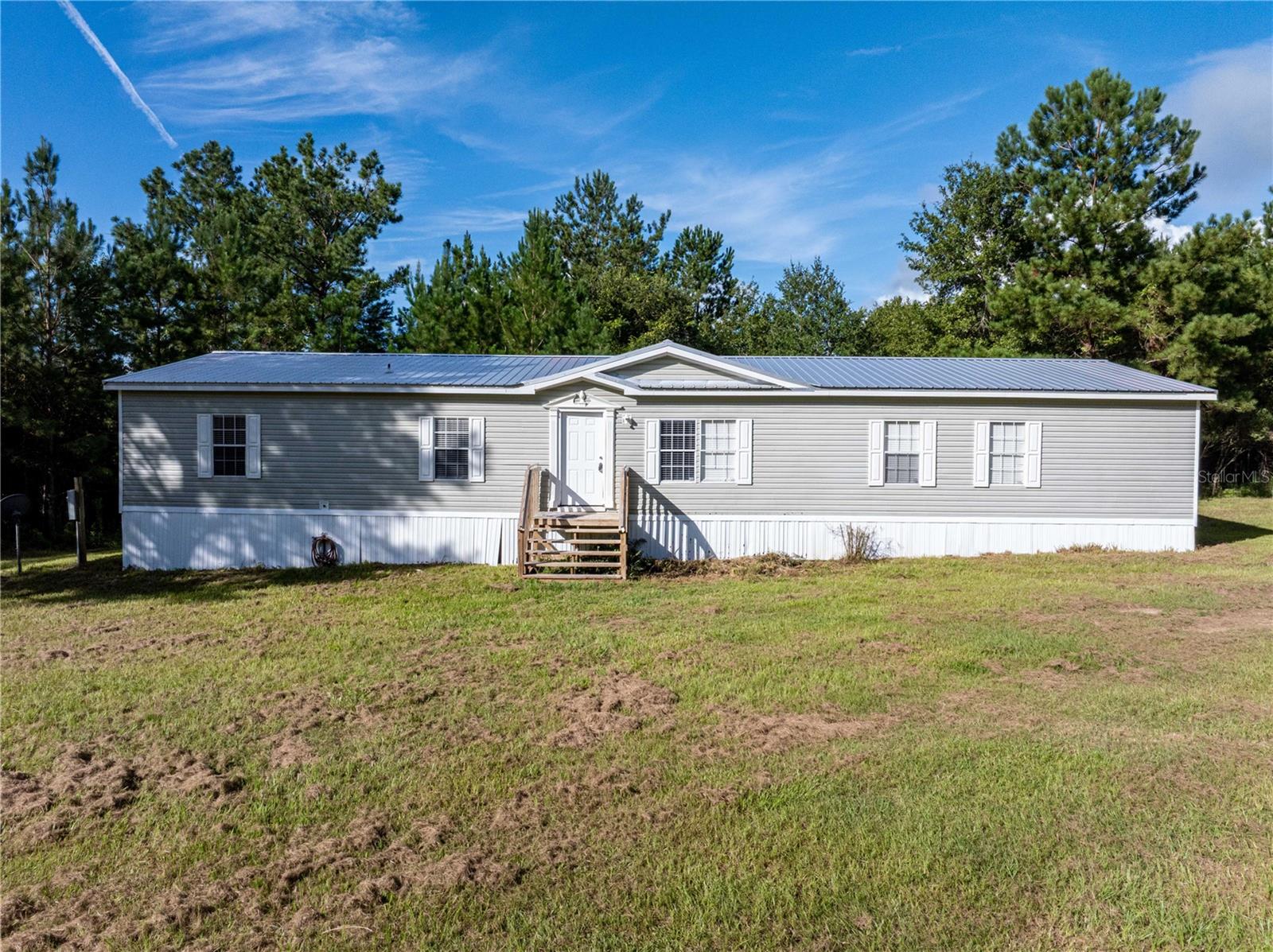 WELCOME HOME!! Tucked away in a quiet cul-de-sac, this inviting 4-bedroom, 3-bath home rests on just under 5 acres of open space. Bright, airy living areas and expansive grounds create the perfect setting for entertaining, gardening, or simply unwinding in total privacy.