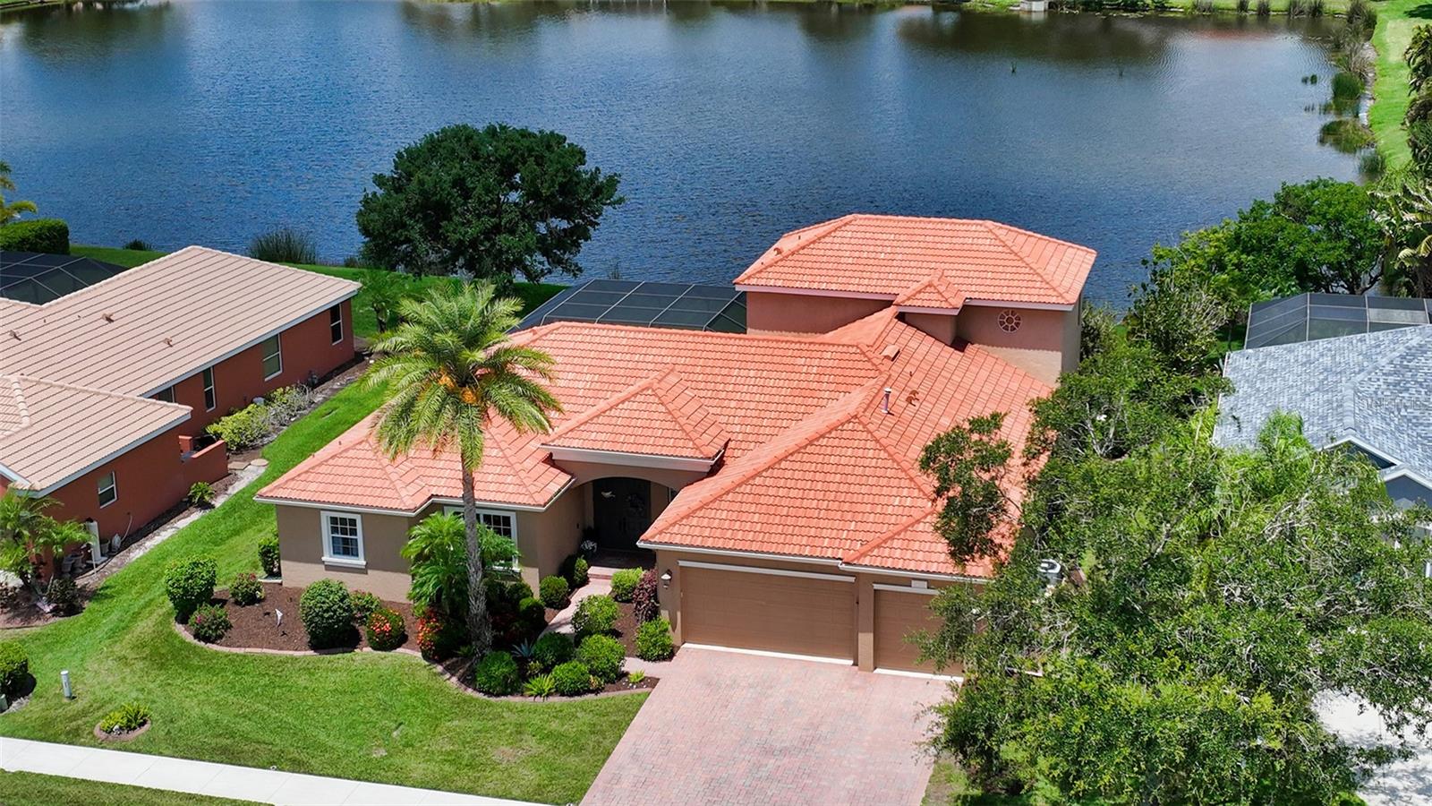 Under contract-accepting backup offers. Welcome to Secluded Oaks a quiet private enclave of 104 homes centrally located but tucked away for a tranquil setting* This 2 story home with expansive lake views boasts of 4 bedrooms plus an office & 3 baths on the first floor with an upstairs bonus room & half bath with wet bar & screened covered porch* Tile throughout living area with easy to maintain laminate flooring in bedrooms & bonus room* Chef's dream kitchen with center island, wood cabinets, granite counters, stainless appliances & gas stove* Breakfast nook with lake views* Formal dining & living room for entertaining* Master features tray ceilings, 2 walk in closets & master bath with jetted tub & separate vanities* Full house hurricane protection* Well for irrigation* Community features natural gas* This home also has central vac* Enjoy your heated (new gas heater) pool/spa with big lake views* Attached 3 car garage* Located near shopping, restaurants, short distance to world famous Siesta Key Beach* Move in Ready!