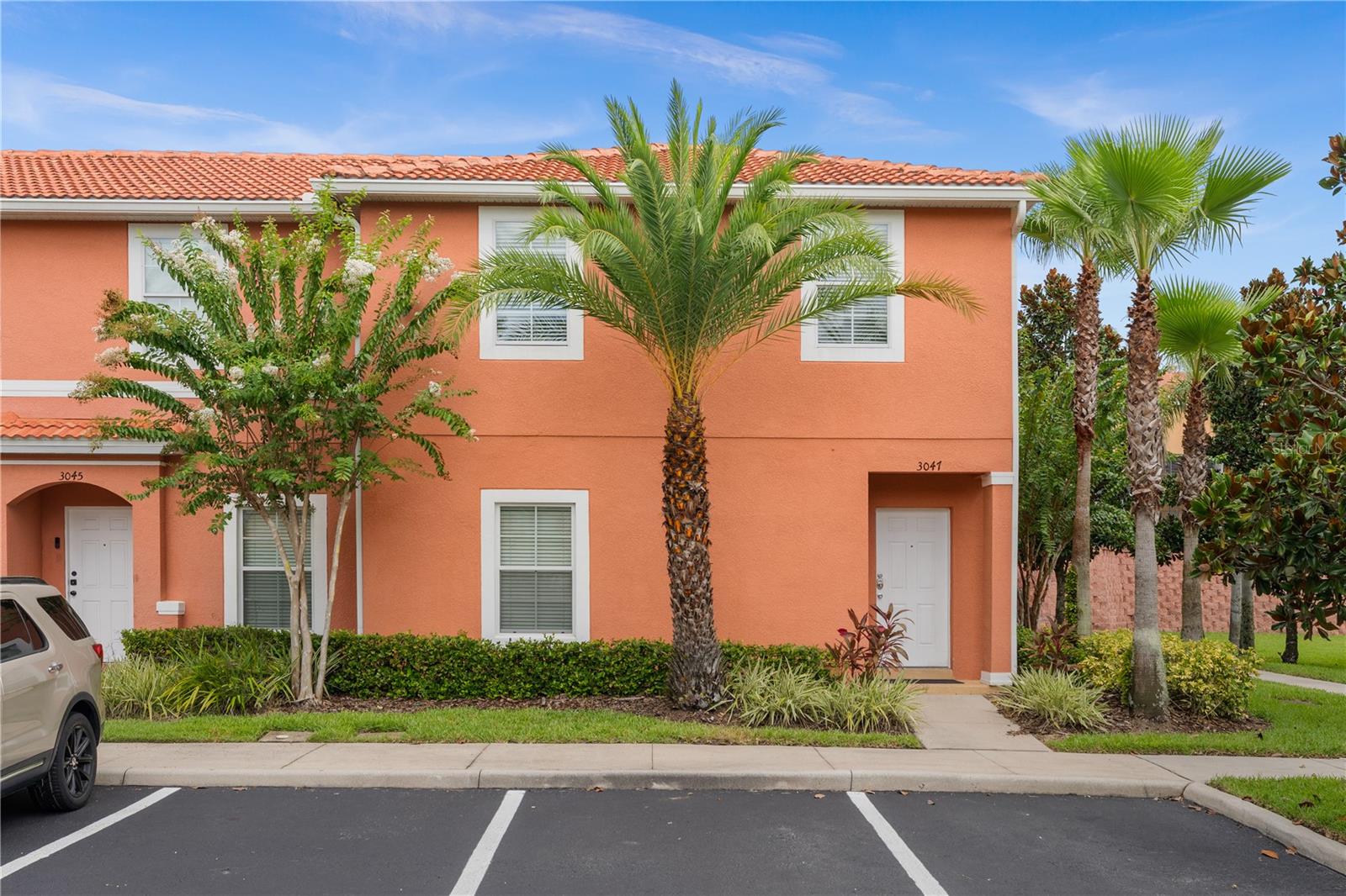 Beautifully furnished 3-bedroom, 2.5-bathroom end-unit townhome with private hot tub in a sought-after resort community—just minutes from Disney and Universal. Welcome to 3047 White Orchid Road, located in the award-winning, guard-gated community of Encantada. Whether you're looking for a turnkey short-term rental investment or a comfortable vacation retreat, this fully furnished end-unit townhome checks all the right boxes. The open-concept main floor is light, bright, and designed for ease of living. The kitchen features striking black granite countertops, warm wood cabinetry, and all appliances. A spacious breakfast bar overlooks the dining area and comfortable living space, perfect for relaxing after a day of adventure. Sliding glass doors lead directly to your private screened-in patio—complete with a hot tub, outdoor dining area, and lounge chairs to enjoy the Florida sunshine. Downstairs is fully tiled for easy maintenance and includes a guest half bathroom and a convenient laundry closet. Upstairs, you’ll find all three bedrooms and both full bathrooms. The primary suite includes a private ensuite bathroom, providing a peaceful retreat at the end of the day. As an end unit, this home enjoys added privacy and natural light, along with the convenience of only one shared wall. Step outside and you’re just a short walk from Encantada’s outstanding amenities. The lakefront clubhouse includes a fitness center, two community pools, playground, game room, business center, and a scenic walking trail. Located just off US-192, you’ll have quick access to restaurants, shopping, and entertainment—and you’re only a short drive to Walt Disney World, Universal Studios, and all of Orlando’s top attractions. With its furnishings already in place, this townhome is move-in or guest-ready—ideal for Airbnb or your own Central Florida getaway. Don’t miss your chance to own in one of the area’s most popular resort communities. Schedule your showing today!