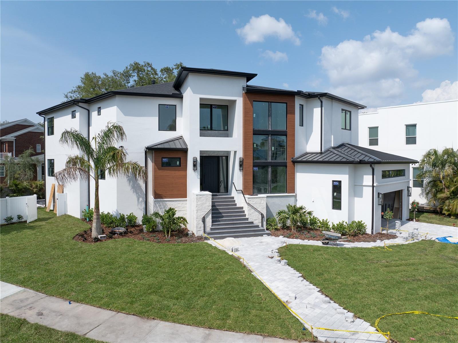 Under Construction. Projected completion April 2025. **Stunning New Construction Home built by Fein Custom Homes in South Tampa**
Welcome to your dream home! This exquisite 5-bedroom, 5.5-bath residence boasts an impressive 5,645 square feet of luxurious living space, situated on a sprawling 0.3-acre oversized lot in the heart of South Tampa. As one of Tampa's most respected and premier builders, Fein Custom Homes has crafted a masterpiece that will exceed your expectations.
Step inside to discover an incredible kitchen that is truly the heart of the home. It features integrated fixed windows, custom white oak cabinetry, and premium appliances, including a 48-inch Wolfe gas range and a 48-inch Sub Zero column refrigerator and freezer, with white oak panel doors. An inviting dining area off the kitchen is perfect for casual dining, while the butler’s pantry/walk-in pantry, equipped with custom wood cabinets, wine fridge, an ice machine, and an integrated in-wall water dispenser, offers ample space and convenience with direct access from the oversized 2.5-car garage for ease with loading and unloading groceries!
The kitchen seamlessly opens into the main great room, where glass sliding doors lead to a spectacular lanai and outdoor kitchen overlooking an inviting Pool with a sun deck and heated spa. Enjoy outdoor entertaining with a sink, grill, and unique features like a pre-plumbed dog wash and outdoor shower, making this space ideal for both relaxation and hosting.
The focal point of this home Is a stunning, custom, floating double steel stringer staircase. It features open risers and elegant white oak treads that merge modern design with warmth. This staircase serves as a striking centerpiece that showcases exceptional craftsmanship while seamlessly blending style with functionality.
Retreat to the primary suite, a true sanctuary with unique wall and ceiling finishes that extend into the luxurious primary bath.
Indulge in premium Brizo fixtures, a stunning
soaking tub, a built-in makeup vanity, and an oversized shower featuring dual showerheads, a handheld option, and a ceiling-mounted rain head. This suite is also pre-wired for a serum refrigerator and makeup mirror, ensuring every detail has been thoughtfully considered. Each secondary bedroom comes with its own private bathroom and spacious walk-in closet, providing comfort and privacy for family and guests alike. This home is a testament to amazing design and timeless elegance, with meticulous attention to detail that surpasses anything you've seen before. The potential for an elevator, offers convenience and accessibility for all generations. There is even room to build a pickleball court making this property perfect for both relaxation and recreation.. Don't miss the opportunity to own this stunning new construction gem in South Tampa-your oasis awaits!
