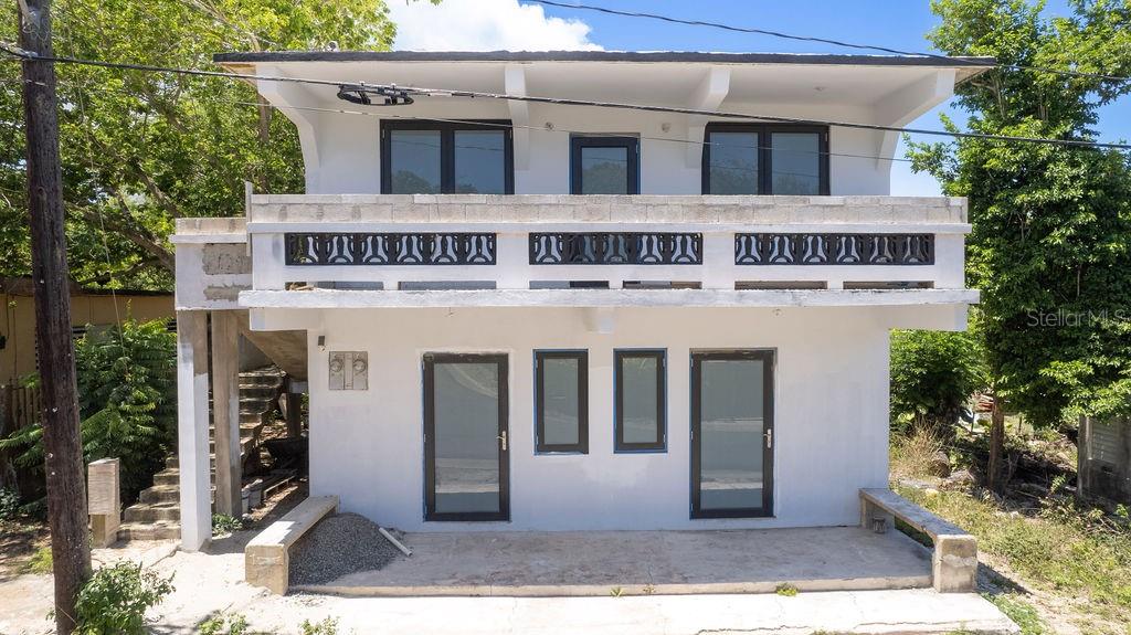 This newly remodeled yet unfinished three unit building, with clean modern lines offers a blank canvas and the flexibility to make it your own. Ideally positioned mid-island, this two-story property is less than four minutes from beautiful beaches, town, the ferry, restaurants, and shops—making it a perfect fit for full-time residents, investors, or vacation homeowners.
The home features three bright, spacious apartments designed with comfort and rental appeal in mind. The two ground-level units each feature 2 bedrooms and 2 bathrooms, a laundry room, and a shared front porch—ideal for morning coffee or evening relaxation. The spacious upper-level apartment also includes 3 bedrooms, 1 bathroom, and a laundry room, with generously sized rooms and its own private balcony, which also provides exciting potential to expand or create a spectacular outdoor living space overlooking the garden.
All units are filled with natural light, and every room offers ample space to enjoy or customize. Whether you finish the interiors to suit your own style or tailor them for premium rentals, this home offers the flexibility to make it truly yours.
The generous rear yard offers ample space for off-street parking, a future pool, and a stylish outdoor entertaining terrace—an added bonus for lifestyle or rental value.
Whether you’re looking to generate rental income, develop a high-value residence, or both, this property offers strong potential for appreciation and return on investment. With the final touches left to your vision, this is your chance to own a standout island property.