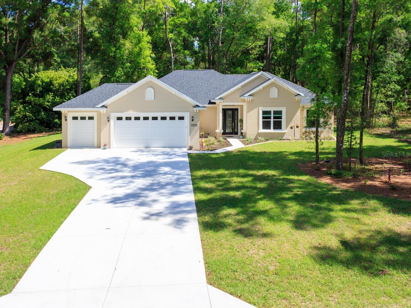 Why wait to build when you can own this brand-new home for less than it would cost to build from scratch with the builder! Nestled in the picturesque Rainbow Springs Forest community, this 2023 custom-built home sprawls across 1.07 acres. Boasting 2202 square feet of living space, featuring 3 bedrooms plus a versatile bonus room suitable for a 4th bedroom, office, or craft space, and 2 bathrooms. Upon entry, be captivated by the airy open floor plan, featuring a spacious 16' x 18' living room adorned with stunning 10-foot coffered ceilings. French glass doors beckon towards the screened lanai, offering a panoramic view of the woodlands behind the home—a serene setting for savoring your morning coffee while observing deer near your doorstep. The kitchen is appointed with custom cabinetry boasting soft-close doors, under-cabinet lighting with under-crown molding, granite countertops, tile backsplash, stainless steel appliances, built-in oven and microwave, wine fridge, coffee bar, walk-in pantry, and a dining room. The owner's suite, measuring 19x13, boasts tray ceilings, dual walk-in closets, dual vanities with ample counter space, and a walk-in shower. Guest bedrooms offer generous proportions and ample closet space. The guest bathroom also features custom cabinets, granite counters, tiled shower walls, and a soaking bathtub. The laundry room, measuring 10'x 14', includes a built-in sink and extra counter space for laundry organization. No home would be complete without a 3-car garage, ensuring ample space for vehicles and recreational equipment. The seller has even painted the garage floor with epoxy to make cleaning up any spills a breeze. The home is loaded with upgrades, including tile flooring throughout the main living areas, 6" crown molding, a top-of-the-line whole-house generator with a 250-gallon propane tank, upgraded front door, recessed LED lighting, 8-foot tall interior doors, broom closet with power outlets for charging cordless vacuums. This home's location offers the perfect blend of peaceful country living and convenient access to modern amenities—just 15 miles from Ocala and the renowned World Equestrian Center. Discover the charm of Dunnellon, a town rich in history, culture, and natural beauty. Stroll through its historic streets, browse charming local shops, and experience the breathtaking scenery of Rainbow Springs State Park, where you can float down the world-famous Rainbow River. As a resident, you’ll also enjoy exclusive access to a private beach on the Rainbow River, reserved only for homeowners in the neighborhood. Don’t miss this opportunity—call today to schedule your private showing of this stunning home!