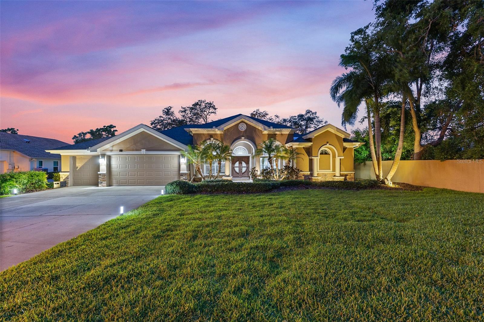 Price Reposition! A Masterpiece of Custom Design in the Heart of Safety Harbor! Welcome to the pinnacle of custom architecture and refined living. Nestled within the prestigious gated enclave of Creekside, this exclusive community is home to just 10 residences, offering unparalleled privacy and tranquility. Ideally situated at the end of a quiet cul-de-sac, this remarkable estate commands the most coveted lot in the neighborhood, an expansive, beautifully landscaped 0.66-acre property that exudes elegance and character from the moment you arrive. Step through the grand custom mahogany double doors and into a light filled interior defined by sophistication and thoughtful design. The expansive Aspen floorplan has been meticulously upgraded to reflect both style and functionality, creating a perfect harmony of luxury and livability. This 4 bedroom, 3 bathroom home plus a spacious den offers an open and split floor plan ideal for today’s lifestyle. Elegant 10 foot tray ceilings, rich crown molding, arched entryways, and custom plantation shutters elevate every living space, while triple sliding glass doors and French doors seamlessly blend indoor and outdoor living, framing stunning views of the pool and lush surroundings. The formal dining and living rooms set the tone for entertaining, but the real showstopper is the oversized bonus/game room, thoughtfully expanded during construction. This impressive flex space offers limitless potential for recreation, media, or multi-purpose use. At the heart of the home lies a chef’s dream kitchen featuring 42-inch custom cabinetry, granite countertops, a large center island, built-in ovens, upgraded stainless steel appliances, a walk-in pantry, and both a breakfast bar and nook for casual dining. Retreat to the serene primary suite, where a private sitting area overlooks the pool, an exquisite touch added during the build. The spa-inspired ensuite bath includes dual vanities, a soaking tub, a walk-in shower, a private water closet, and two custom walk-in closets. The secondary bedrooms are generously sized and offer ample storage, while the additional bathrooms are adorned with high-end cabinetry and finishes, continuing the home’s cohesive design. Outdoors, your private oasis awaits. The resort-style heated pool features a PebbleTec finish, sun shelf, deck jets, and custom LED lighting with Bluetooth controls. The extended lanai, complete with mansard-screened enclosure, provides two expansive covered areas perfect for alfresco dining or lounging in luxury. The fully fenced backyard is a true sanctuary, surrounded by majestic oak trees, Areca palms, and lush St. Augustine grass, offering plenty of space for outdoor recreation and relaxation. Additional upgrades include integrated smart home Alexa features with voice-activated lighting and outlets throughout. Creekside offers an unmatched location just 5 minutes from charming downtown Safety Harbor, renowned for its shops, restaurants, street festivals, and small town charm. Also nearby are Philippe Park, local beaches, and both Tampa International and St. Pete-Clearwater airports, just a short 20-minute drive away. Homes of this caliber are a rare find. Don’t miss your chance to own a piece of architectural excellence in one of Safety Harbor’s most coveted communities.