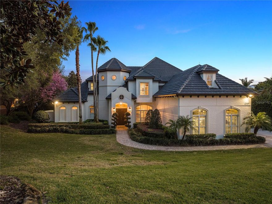 This luxurious Mediterranean lakefront home has unparalleled luxury and tranquility with over 6,200 square feet of A/C living, six bedrooms, 5.5 baths, a pool and spa, wine cellar, game room, bonus room, and an oversized 4 car garage all wrapped up in a 1.25-acre piece of illustrious lakefront heaven. As you enter through the grand foyer, you will be greeted by large windows with views of John’s Lake, soaring ceilings, a sweeping staircase, and an abundance of natural light. The open floor plan seamlessly integrates the living room, which offers a linear fireplace and custom built-ins for your TV, dining room, and kitchen, creating an ideal space for entertaining guests or spending time with family. The gourmet kitchen is a chef's dream, with top-of-the-line appliances, a large center island, and a breakfast bar. The adjacent dining room can accommodate a large table for formal gatherings, while the living room features a cozy fireplace and gorgeous lake views, making it an excellent place for conversation or reading a book when you need a little peace. The master suite is a true oasis, with walk-in closets, a spa-like bathroom with a soaking tub and separate shower, and a private outdoor area outside the bath to sit and dry off in nature's beauty. The additional bedrooms are all spacious and well-appointed, each with a private bathroom. The backyard is an entertainer's paradise, with a custom-designed pool and spa, a large covered patio, and a lush lawn extending to the private boat dock. The backyard also offers stunning views of John's Lake, making it the perfect place to relax and enjoy the Florida lifestyle. If you love the views, you will love the activities. If you are into entertaining, enjoying a large summer BBQ in the backyard, playing frisbee golf, or hanging with friends and family, wake surfing, tubing, or fishing. There are endless activities you can take advantage of. The location of this property is also worth mentioning. The home is minutes from DT Clermont, DT Winter Garden, Disney, and all of the Orlando attractions. This luxurious waterfront estate is truly one of a kind. It is the perfect place to call home for those who demand luxury, tranquility, and convenience.