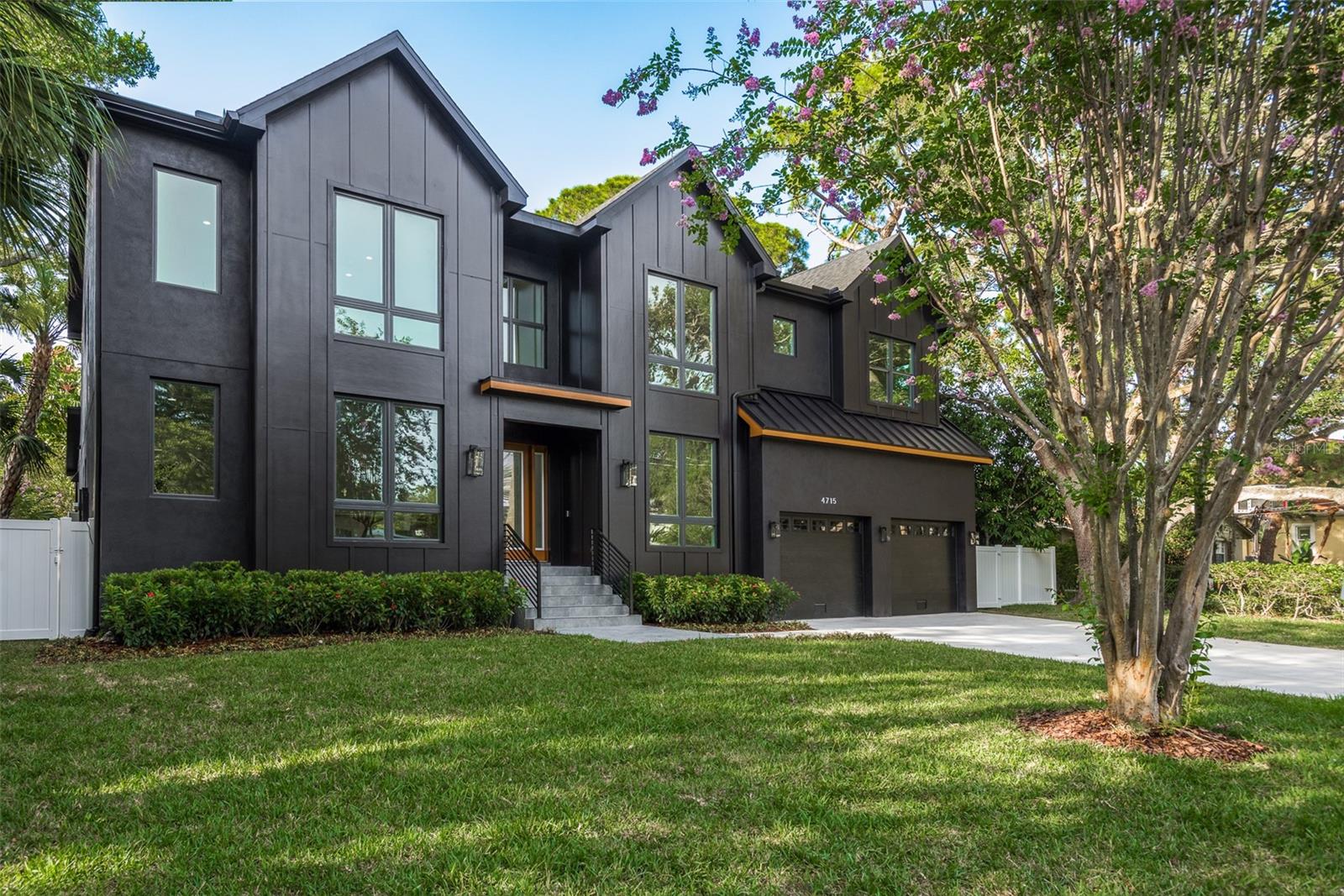 Welcome to an exceptional 5-bedroom, 4.5-bathroom residence with an office and a spacious 2-car garage. This striking black-on-black masterpiece is designed to captivate from the very first glance. The grand entrance, featuring soaring ceilings and an elegant wood staircase, sets the stage for the grandeur that lies beyond.
Inside, the well-designed floor plan boasts an office with French doors, a formal dining area, and a butler's pantry leading into a brilliantly equipped kitchen. The kitchen, a haven for any culinary enthusiast, showcases European-style cabinetry extending to the ceiling, Level 5 quartz countertops, and top-of-the-line appliances. It opens into a sunlit breakfast area.
The great room, with its floor-to-ceiling wood accent wall, wood-beam ceiling, and bifold impact glass doors, seamlessly connects to the impressive outdoor lanai. The backyard offers a true sanctuary with a large travertine lanai, a pristine pool, heated spa, and an outdoor kitchen with a gas grill. A side door from the lanai leads to a versatile main-floor guest bedroom or bonus space with its own ensuite.
The second floor hosts four beautifully appointed bedrooms and a separate bonus room, perfect for gaming or as a children's retreat. The master wing is a private haven, featuring the largest his-and-hers closets you've seen in Tampa, a spacious bathroom with double sinks, a soaking tub, and an oversized glass shower.
This home is a masterpiece of luxury and modern convenience. It showcases high-end finishes throughout, including hardwood flooring, smooth level 5 finish drywall, 8' solid core doors, hurricane impact windows and doors, and a shingle/aluminum roof. Located in the sought-after Mabry/Coleman/Plant school district, this residence offers the ultimate in luxury living.
This is a rare opportunity to own a home that redefines the meaning of luxury. Don't miss your chance to experience the epitome of Tampa living. Contact me today to schedule a private viewing. This unparalleled residence awaits, offering you the lifestyle you've always dreamed of.