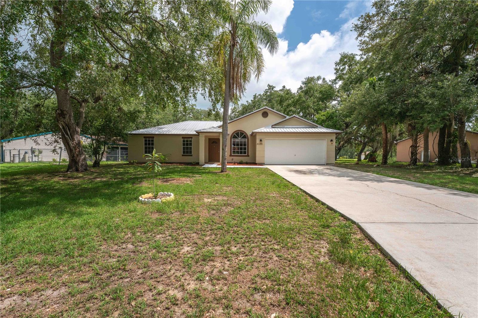 Welcome Home! This updated Port LaBelle home has been freshly painted inside and out, the electrical system was updated in 2023, new range 2025, new primary bedroom shower 2025 and new toilets 2025. The metal roof is newer and the home is on Public Utilities. Located on a quiet street and a pie-shaped lot, the large yard is perfect for you to spread out. Seller offering $15,000 kitchen remodel concession with acceptable Offer. This home is located within walking distance of LaBelle High School and qualifies for 0% Down and NO PMI; contact us for details (information also attached under the paperclip).
