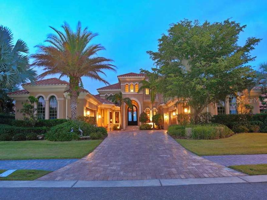 Beautifully positioned within the gates of Hawk Island, a prominent enclave of homes on the Manatee River, this luxurious home presents an elegant expression of waterfront living. The over 5,700 sq. ft. of living area, with garage parking for 5 automobiles, offers comfortable spaces in which to live, to relax and to entertain -- including, 2 master suites, 2guest suites, 6 baths, a game room, theater room, wine room, wet bar and gourmet kitchen. The first floor owner's suite provides a tranquil escape overlooking the river, while an elevator will whisk you to the additional second level master retreat. Outdoor living is just as spectacular, with an infinity edge saltwater pool and summer kitchen creating gorgeous spaces, along with a small private beach to enjoy the Florida sun. Enjoy direct access to the Gulf of Mexico from your private dock, which will accommodate a vessel of up to 60 ft, or cruise along the river by Jet Ski from your electric lift. A second electric lift provides harborage for a smallto midsize sailboat. Perfectly located to offer both privacy and modern convenience, residents of Hawk Island are just a short drive away from excellent shopping, dining and Gulf Coast beaches.