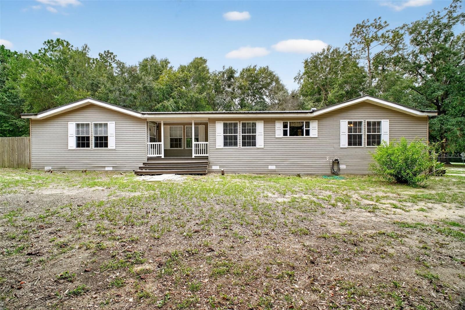 Situated on a full acre of agriculturally zoned land, this property offers a rare blend of residential comfort and functional utility. The spacious 2,200 sq ft manufactured home, with 4 bedrooms, and three full bathrooms is ideal for larger families, or multi-generational living. Additionally, the 17' x 34' metal building with solid slab floor and fully wired for electrical, is perfect for equipment storage, workshop use, or conversion to suit your needs. With ample space and flexible zoning, this property is well-suited for hobby farming, small-scale operations, or simply enjoying the peace and privacy of rural living, all within minutes to schools, shopping, and medical facilities. New septic drain field in 2025. Whether you're looking for a homestead, investment opportunity, or a practical setup for work and play, this property delivers.
