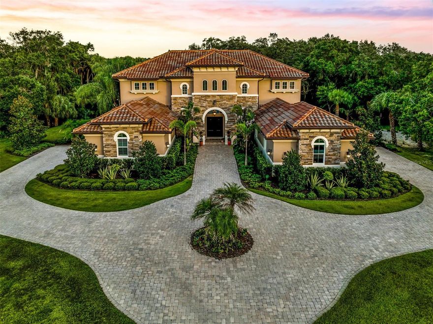 Welcome to the Forest at Hi Hat Ranch. The Forest is a private community of 54 total lots on over 270 acres in Sarasota, Fl with electronic
gates, a private Gazebo Park, and a no-repeat architecture rule – no two homes are alike within the community. This 5 bedroom 6 ½
bathroom estate home will wow you front moment you drive onto the paver driveway. The home sits on 4.3 acres of mature landscaping
and boasts 5.284 SqFt under air. This is a custom-built home with no details spared; including a four-car garage to meet all your storage
needs. Many custom features include draperies, remote blinds, and plantation shutters. This 2016 Mediterranean style home commands a
strong presence from the outside to the inside with 30-foot-high ceilings in the foyer to the enormous outdoor entertainment center. The
caged heated pool and spa includes a summer kitchen, fireplace, and multiple gathering areas for the best entertaining. Stylish flooring
throughout, unified with modern tile, wood, and luxury vinyl floors. Grand living room with soaring custom tray ceilings with view to pool
and lush backyard. Gorgeous kitchen with large cafe area and top of the line appliances including Thermador fridge/freezer, an ice maker,
huge butler’s pantry, wine fridge and wine closet. Propane (buried) services for cooktop, fireplace, and outdoor kitchen. The Bonus family
room upstairs includes kitchenette with dishwasher and accesses large second floor balcony for impressive views of property and caged
pool. Safety and security are built into this home with outdoor cameras, and Google home security system. In addition to landscaping lights and two HVAC systems zoned for efficiency. Connection for
independent gas-powered generator. If you are looking for privacy in a secure environment, look no further- the Forest at Hi Hat Ranch is
for you. Don’t wait; schedule your showing today of this estate home. 3D Matterport video available in virtual tour.