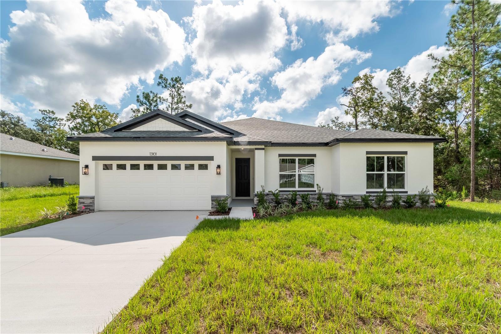 Ask about our Builder Incentives! Impeccably designed new construction 4-bed 3-bath home located in a great central Marion Oaks location close to everything Ocala has to offer! From the moment you arrive you will notice the difference with volume 9'4'' ceilings throughout the entire home. The main living space is centered around the living Room with stunning 8' triple panel sliding glass door that overlooks the covered lanai which perfectly integrates the indoor/outdoor living space. The kitchen showcases Dolce White Quartz countertops, Samsung stainless steel appliance suite (3 Year Warranty), 42'' upper cabinets, and entertaining island. Owner's Suite features trey ceiling, oversized dual sink vanity, tastefully designed shower with glass enclosure, and his & hers walk-in closets. All guest bedrooms are well sized with ample closet space. The Guest Suite had a private en-suite bathroom making it perfect for a JR. Suite. Both Guest bathrooms feature tub/shower combo with floor to ceiling tile as well. Spacious Laundry room with an additional linen closet for added storage, plus the washer and dryer are included in the sale! Schedule your private tour today.