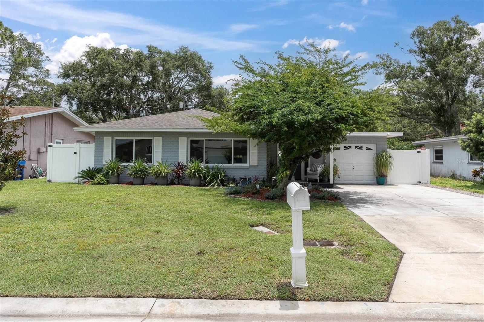 Welcome to your private oasis in the heart of highly sought-after Dunedin, Florida! This stunning and fully renovated 3-bedroom, 1-bathroom pool home offers the perfect blend of modern comfort and coastal charm. Step outside to enjoy your brand-new saltwater pool surrounded by 1,400 square feet of sealed pavers (June 2024), lush tropical landscaping, and a peaceful backyard retreat that feels like your own resort. Inside, you'll find a spacious living room, a separate dining area, and an upgraded kitchen with stone countertops and stainless steel appliances. The entire home features beautiful wood-look ceramic tile flooring, new 5-inch baseboards, fresh interior paint (2025), and barnyard-style closet doors in the second and third bedrooms. With sizeable bedrooms and a beautifully remodeled bathroom with a soaker tub, there is plenty of room for guests. Major updates include a new AC, new water heater, and hurricane-rated exterior doors. The property also includes a one-car garage and dedicated golf cart parking behind the fence, located in a golf cart-friendly neighborhood. Just a short walk from Hammock Park, Kiwanis Sprayground, Dunedin Art Center, and the local Little League fields—and only minutes by bike to Honeymoon Island or by golf cart to downtown Dunedin, this home delivers the best of Florida living. Don’t miss your chance to own this move-in-ready gem!