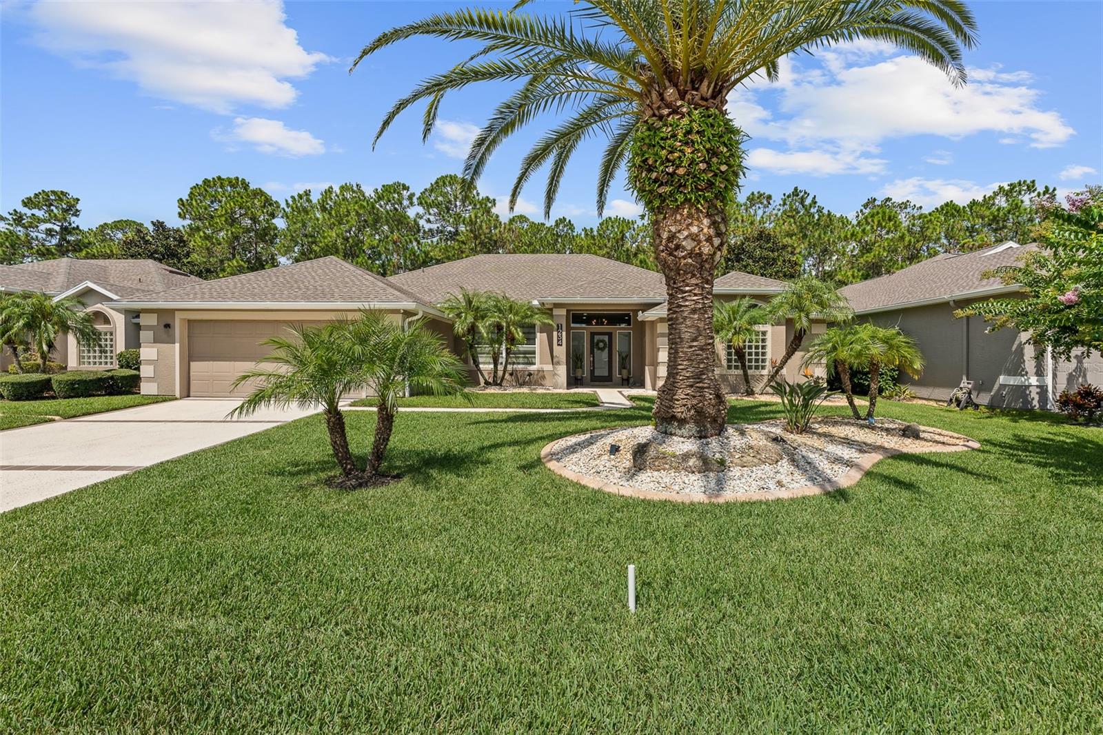 Stunning Pool Home in Plantation Bay, RENOVATED and NEWER ROOF! Welcome to this beautifully upgraded residence in the sought-after gated community of Plantation Bay. From the moment you step through the double glass front door, you'll be greeted by elegant 24x36 tile floors, crown molding, and an abundance of natural light. The formal living room offers a grand first impression with pool views and seamless access to the open living area. A formal dining room features oversized tile floors, custom blinds, crown molding, and a stylish accent wall—perfect for entertaining. The heart of the home is the completely renovated kitchen, showcasing double-stacked cabinetry to the ceiling, quartz countertops, soft-close dovetail drawers, tile backsplash, a pantry closet, and premium KitchenAid stainless steel appliances. The adjacent breakfast nook is surrounded by large windows overlooking the pool and preserve and has direct access to the lanai. A spacious family room invites cozy gatherings with its shiplap accent wall, electric linear fireplace, large windows with views of the preserve and pool, and crown molding throughout. Retreat to the primary suite featuring tray ceilings, private access to the lanai through sliders, and dual walk-in closets. The spa-like primary bath offers separate vanities with quartz countertops, custom beveled mirrors, a walk-in shower, and a large soaking tub. Split floor plan with 3 additional bedrooms offering flexibility for guests or a home office, while the second full bath includes pool access and a tub/shower combo. Step outside to a private oasis featuring a newly added resort-style pool with a fountain wall, stacked stone accents, a sun shelf with bubblers, and a fully fenced dog run. Enjoy outdoor living year-round with a covered lanai and electric awning for added shade. Additional features include: 2022 Roof, NEW re-drilled irrigation well, Rock bed landscaping and mature plantings, Interior laundry room with cabinetry, Deep garage with room for 2 cars plus golf cart with utility sink, 2024 HVAC and water heater, Whole-house water filtration system, Ecobee smart thermostat, Renovated kitchen, 6 new large picture frame windows, plus much more. Located in the prestigious Plantation Bay Golf & Country Club, this community offers optional membership access to 45 holes of championship golf, two clubhouses with new 30 million dollar clubhouse, a resort-style pool, full-service spa and fitness center, 9 tennis and 10 pickleball courts, walking trails, and dining, all within a beautifully maintained, gated setting with 24/7 security. This is Florida living at its finest! Schedule your private showing today!