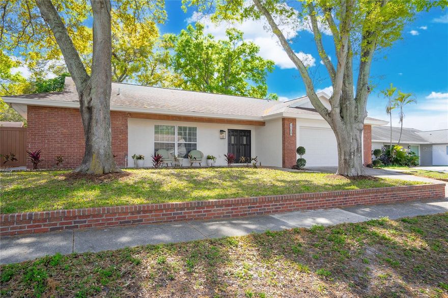 Welcome home to beautiful Palm Harbor in unincorporated Pinellas County. This beautifully remodeled 3-bedroom, 2-bath home has been thoughtfully updated with timeless style and modern finishes throughout, including new wide plank luxury vinyl flooring throughout the entire home.
As you arrive, you will immediately notice the inviting red brick accents that run from the sidewalk to the front of the home, along with a welcoming front porch perfect for rocking chairs and a glass of lemonade. Step through the large double front doors and you are greeted by an abundance of natural light and oversized double hurricane-rated sliders that open to a pavered, screened-in patio featuring a large pool, outdoor shower, mature landscaping, and custom wood-look vinyl fencing.
The completely renovated kitchen is a true centerpiece of the home, showcasing custom jade-colored cabinetry, pearl white quartz countertops, and champagne bronze fixtures. The kitchen flows seamlessly into the spacious living area, creating an ideal layout for both everyday living and entertaining.
The primary suite is a true retreat, featuring its own private library space that can also serve as a home office, nursery, or reading room. With direct access to the patio, this suite offers both comfort and privacy. The spa-inspired primary bathroom includes custom glass, imported tile, and a beautifully designed custom vanity.
On the opposite side of the home, you will find two generously sized guest bedrooms with ample closet space. The guest bathroom has also been fully remodeled with stylish finishes, making the home truly move-in ready. The home also features a large private laundry area with custom tile work and a two-car garage.
Located in desirable Palm Harbor, this beautifully updated home offers comfort, style, and convenience in one of Pinellas County’s most sought-after areas. Schedule your private showing today.