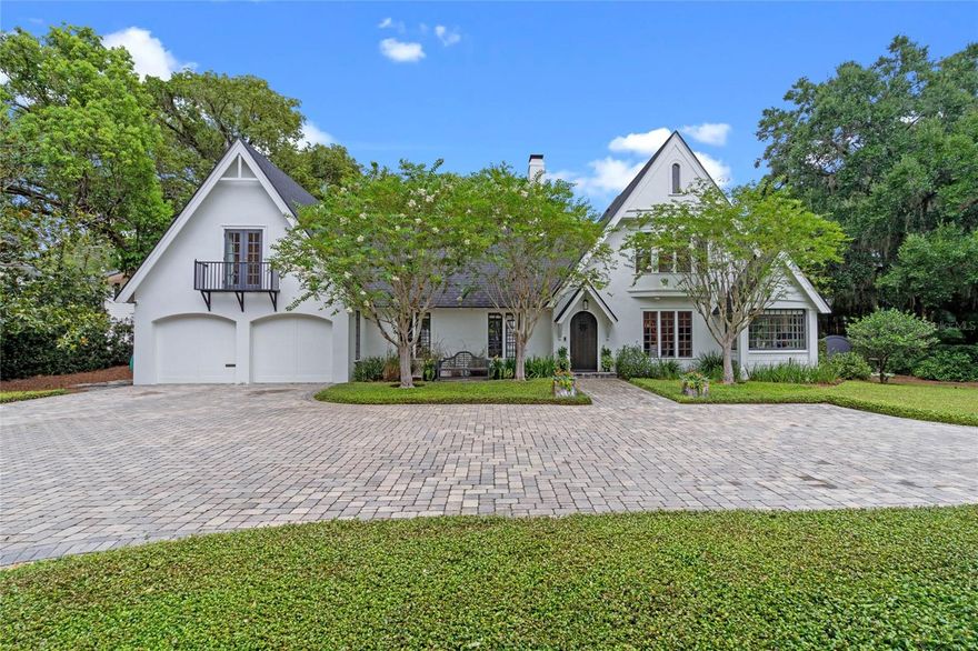 This fairytale property is located in the gracious neighborhood surrounding Park Avenue known for homes of unique character & historic architecture. The main home was originally built in 1918 & has been thoughtfully renovated to modernize the home’s function while maintaining the architectural integrity. It is located in the heart of Winter Park on a rare half acre, corner lot w/ charming views of the Winter Park Country Club & golf course. The semi-circular driveway that connects to both Webster & Old England provides convenience & enhances the curb appeal. Upon arrival, your guests will immediately appreciate the lush landscape, the dynamic & steeply pitched roof, overlapping, front-facing gables & charming, arched front door popular w/ Tudor style homes. Inside the foyer & through the arched doorway to the left, this home opens to an expansive, formal living space featuring cathedral style, volume ceilings ornamented w/stained, hand hewn oak, wood floors, tall windows, french doors overlooking the brick courtyard & an elegant, floor to ceiling, wood burning fireplace. To the right of the foyer are the formal dining & sitting rooms w/ long, rectangular windows clustered together offering an abundance of natural light to these richly detailed yet comfortable interior spaces. Towards the back, right side of the home, the spacious kitchen opens to an eat-in area, family room & stairs leading down to the basement wine storage. The kitchen features real wood cabinets, black granite counter tops, a sizable island w/seating for five, a Subzero refrigerator, Viking gas range & oven w/stainless steel vent hood, double-bowl, under-mount sinks, commercial style faucet, ice maker, prep sink, under counter microwave, a pantry & a large closet-style storage space allowing for easy access to your favorite serving pieces. The eat-in area & family rooms feature multiple sets of french doors through which you are provided beautiful views of the fountain at the center of the courtyard, pool & backyard haven. The layout of the main house includes a 3-way split plan w/ all bedrooms & bathrooms on the 2nd floor. The primary is located on the left side of the home and is accessed through a rear stairwell. This spacious suite is equipped w/ a walk-in closet, Juliet balcony & charming bathroom featuring a wood vanity, marble countertop & a shower/tub combination w/ floor to ceiling white subway tile. The two alternate bedrooms & bathrooms are accessed from the entry stairwell. The front, right alternate bedroom suite features a spiral staircase w/ loft. The rear, alternate bedroom suite is adjacent to the roof top deck. Both are rich w/ character showcasing wood floors, extensive millwork, renovated baths w/shower-tub combination, white subway tile, bead-board & pedestal sinks. The guest house was built in 1925 & is located on the far side of the courtyard. It includes a full kitchen, general living space, laundry room & half bathroom on the 1st floor as well as 2 bedrooms & 1 ½ bathrooms on the 2nd floor. This flexible space could be used in myriad ways. A rear, gated driveway w/ access from Old England is located at the NE corner of the property & is discretely hidden behind a jasmine covered wall. This is the first time this century that this Old Florida property w/ its storybook exterior architecture, majestic oaks & private courtyards that leaves you w/ a rare feeling of deep connection & an undeniable sense of place is being offered for sale.