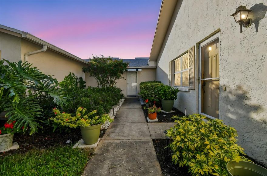 Welcome to West Shore Village, a beautifully maintained, all ages, gated community tucked away in one of St. Petersburg’s most desirable locations. This first-floor, villa-style condominium offers the rare combination of single-story living, a spacious screened-in lanai, and a private garage with direct access the unit. Located in an X non-flood zone and positioned in one of the highest, most elevated sections of the community, this unit sustained no damage from past storms, offering peace of mind that buyers value more than ever. The private garage is fully drywalled, recently serviced, and provides convenient direct access into the home, with plenty of nearby guest parking for visitors. Inside, the layout is efficient and comfortable, with a spacious bedroom filled with natural light, a large built-in closet, and a bright living space that flows seamlessly to the screened lanai, complete with privacy shades - perfect for morning coffee or quiet evenings outdoors. Upgraded electrical and plumbing add to the home’s long-term reliability. West Shore Village is an all-ages community known for its strong financial health, with fully funded HOA reserves and well-kept grounds. Amenities include a beautiful resort style pool, clubhouse, and tennis and shuffleboard courts, all within a secure, gated setting. The unit can be sold fully furnished as shown, making it ideal as a primary residence, second home, or low-maintenance Florida retreat. Conveniently located near downtown St. Petersburg, Gulfport, beaches, shopping, dining, and waterfront trails—this home offers the perfect balance of privacy, security, and accessibility.