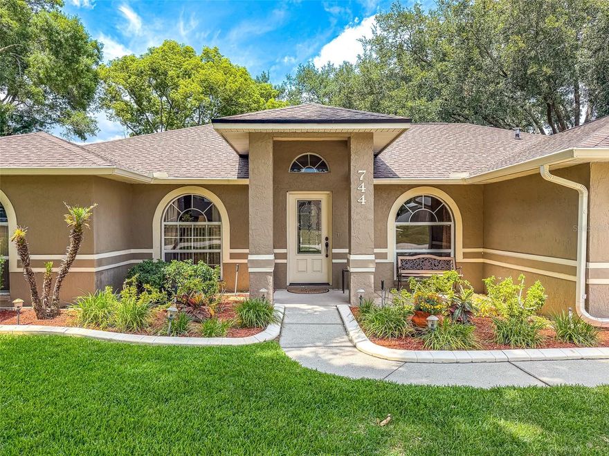 This beautifully appointed 3-bedroom, 2-bath residence offers an exceptional blend of space, comfort, and refined living—enhanced by major recent upgrades, including a newer roof installed in October 2021 and a modern AC system replaced approximately 2022–2023, providing peace of mind for years to come. Located in a USDA-eligible area, this home also offers the potential for 100% financing for qualified buyers.



Designed with versatility in mind, the home features an expansive bonus room currently utilized as a private office—ideal for a sophisticated work-from-home setup, media room, or potential fourth bedroom. A welcoming entry with a classic coat closet opens into a thoughtfully designed layout, showcasing both open-concept living and a desirable split-bedroom floor plan.



Rich natural wood flooring flows through the main living areas, creating warmth and elegance, while tile and plush carpeting provide comfort within the bedrooms. A dedicated dining room offers the perfect setting for intimate dinners and entertaining guests, complemented by tasteful recessed lighting throughout.



The oversized primary suite serves as a true retreat, complete with a massive walk-in closet and a spa-inspired ensuite bath featuring granite countertops, dual vanities, a luxurious soaking tub, separate walk-in shower, and additional storage. Private access to the outdoor patio enhances the suite’s tranquil appeal. The third bedroom also features its own walk-in closet, adding to the home’s thoughtful design.



Abundant storage can be found throughout the home, offering both functionality and convenience. The washer and dryer are included, making this home truly move-in ready.



Step outside to your own private outdoor oasis, where meticulously maintained landscaping surrounds the property. Enjoy mature fruit trees, including banana and orange, creating a serene and lush setting perfect for relaxation or entertaining. The fully fenced backyard also features seamless gutters, two outdoor power outlets, and two storage sheds for added versatility.